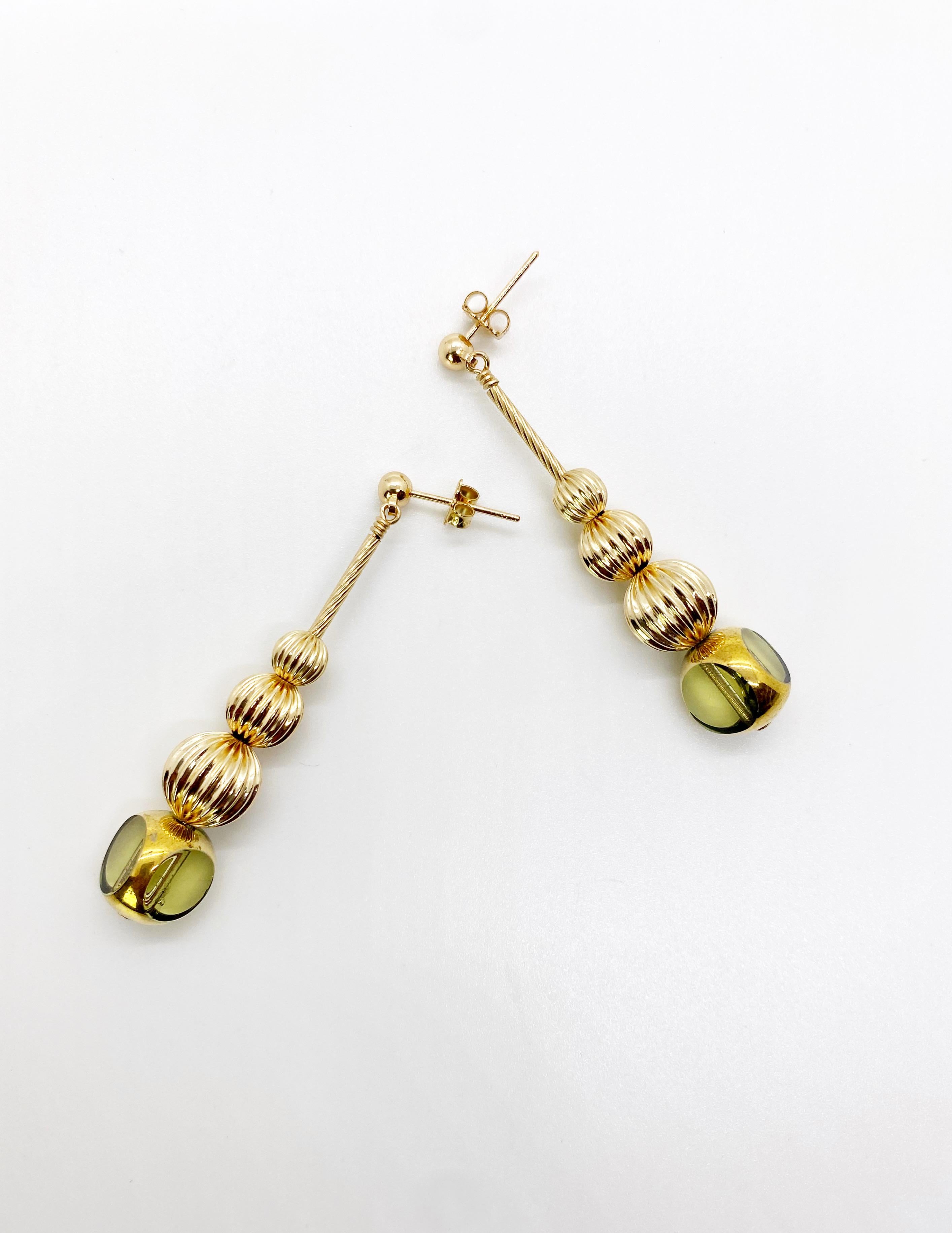 This is for a pair of earrings. This is a listing of a pair of earrings. Each earring consist of 1 semi-round translucent lemon chiffon colored German vintage glass beads that are first plated with platinum and then plated with 24K gold. They are