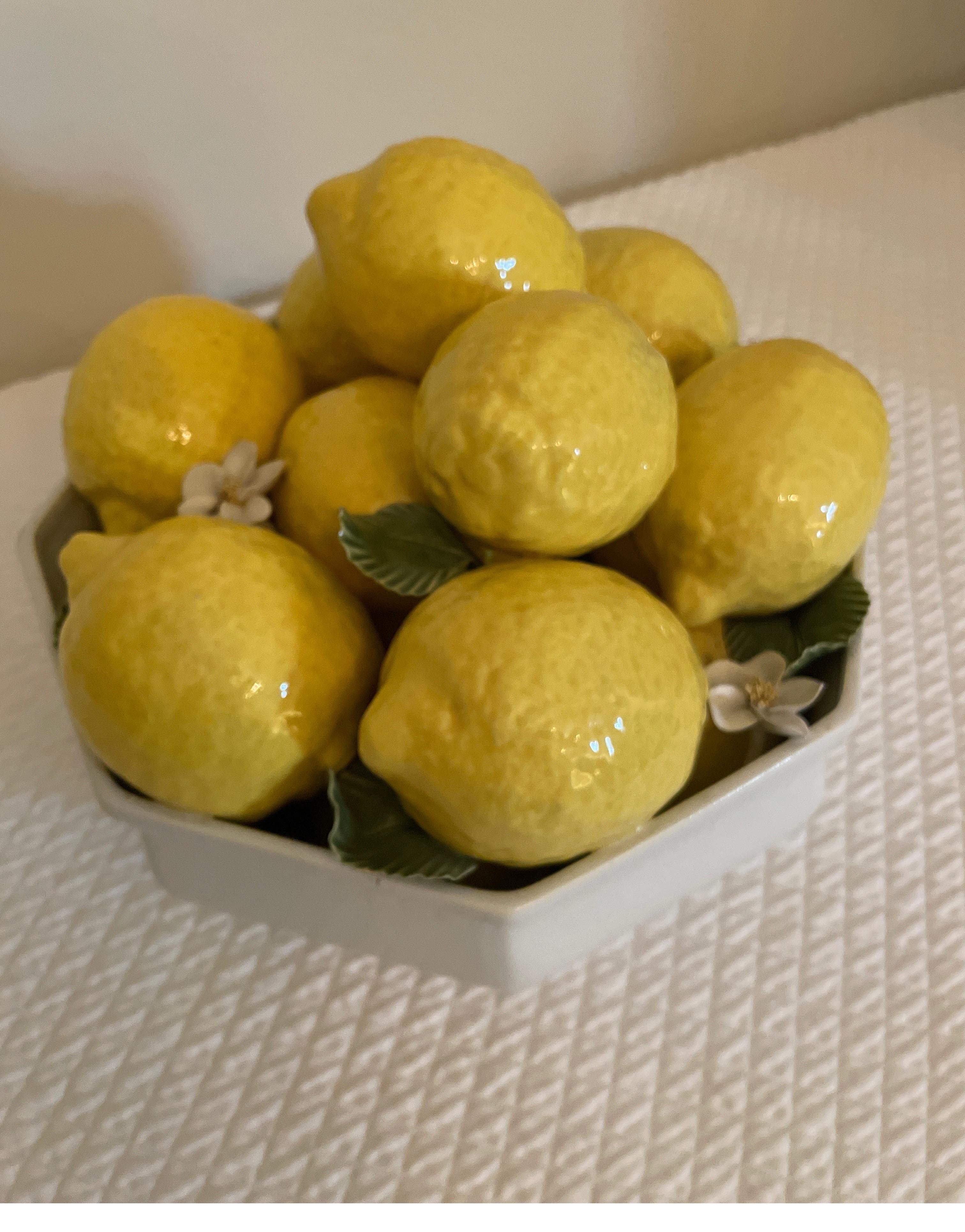 Vintage Italian Lemon centerpiece. White porcelain bowl filled with lemons & green leaves with white flower petals. Very pretty centerpiece for your table or buffet.