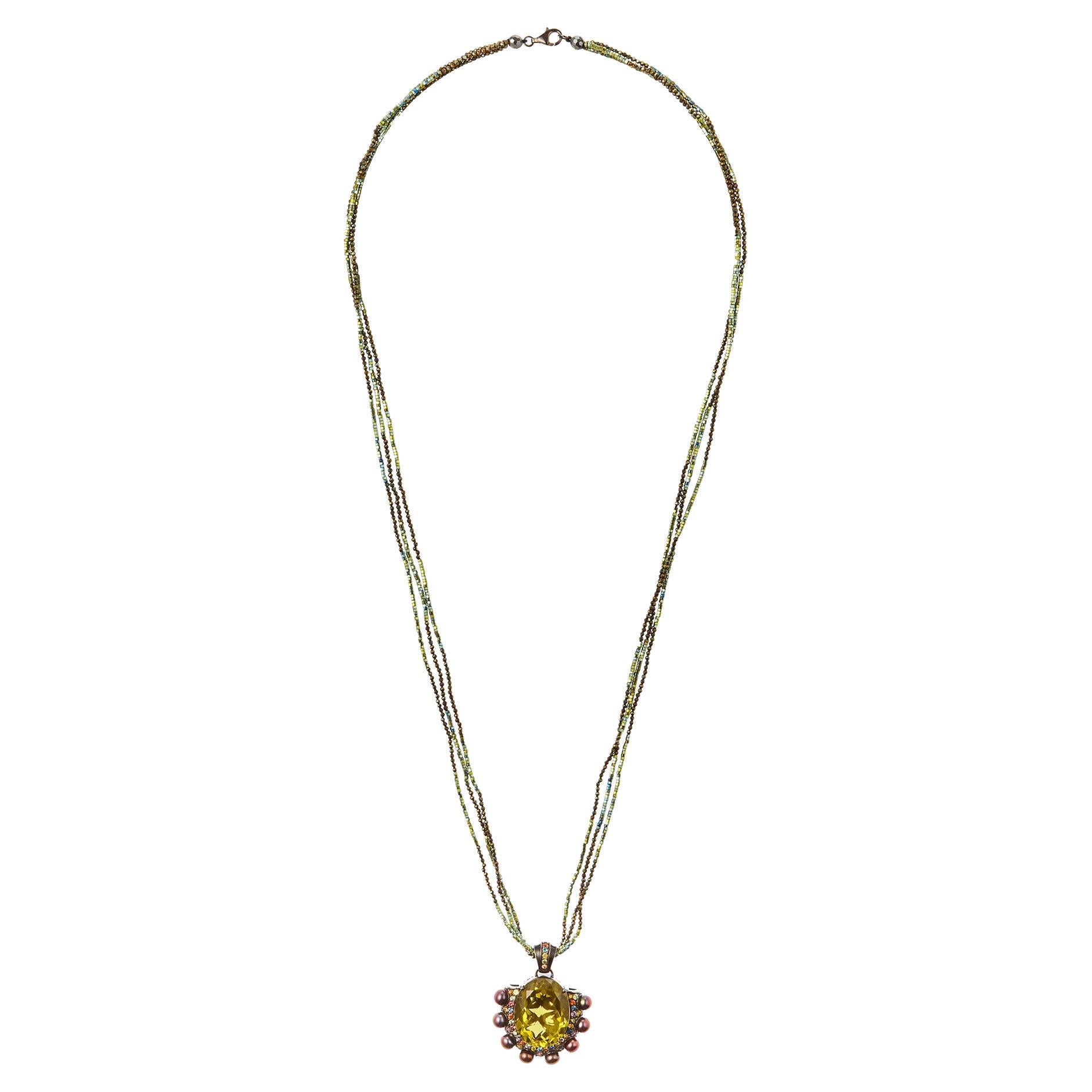 Make a bold and unforgettable statement with the Lemon Quartz, Mixed Sapphires & Black Pearl, Hematite Beaded Statement Necklace. This extraordinary piece showcases a stunning lemon quartz centerpiece, with its delicate pale yellow hue offering a