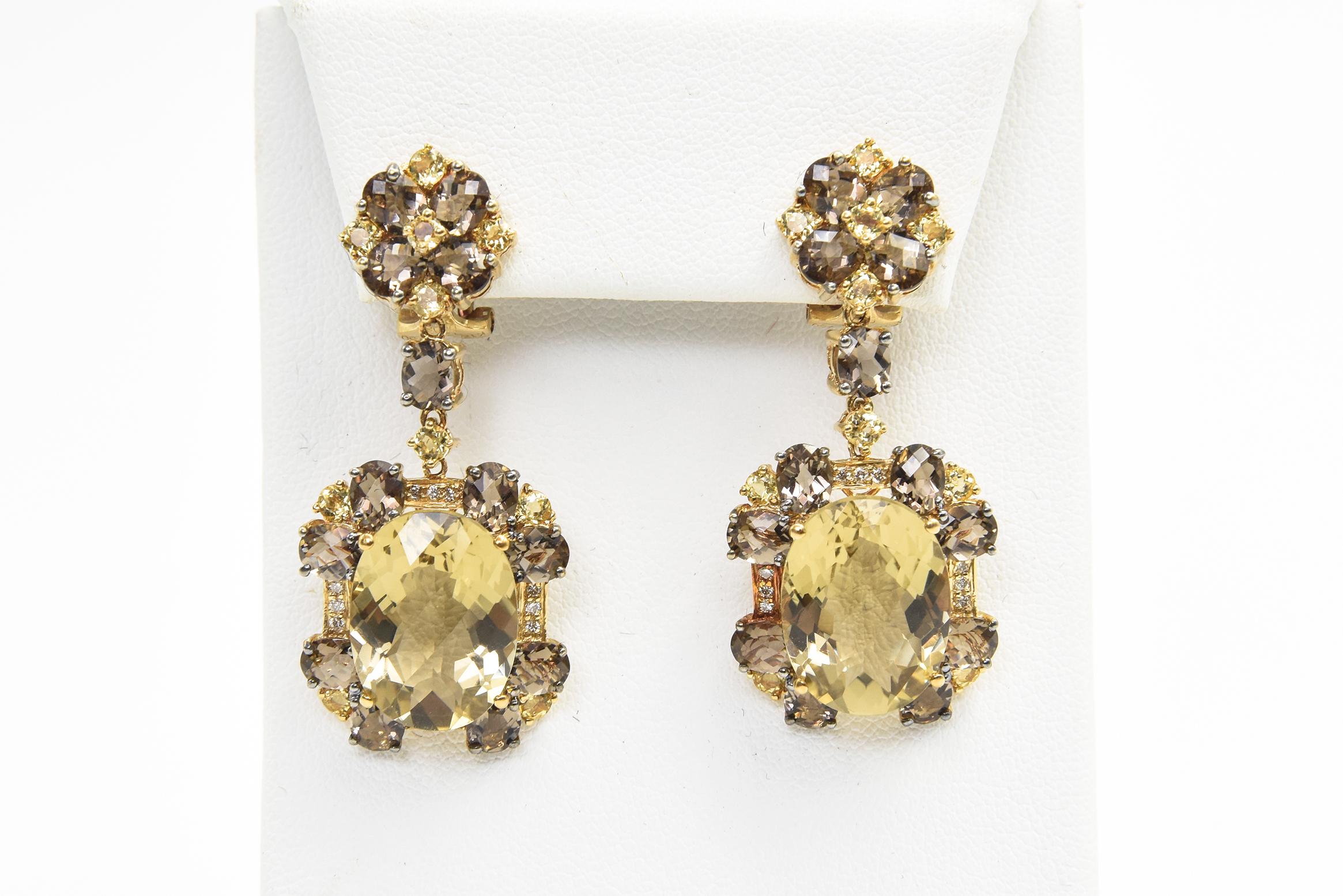 Beautiful dangling 18k yellow gold dangling earrings featuring a yellow beryl & smoky topaz flower on ear which leads to dangling framed oval lemon quartz with diamond and yellow beryl and smoky topaz accents.  