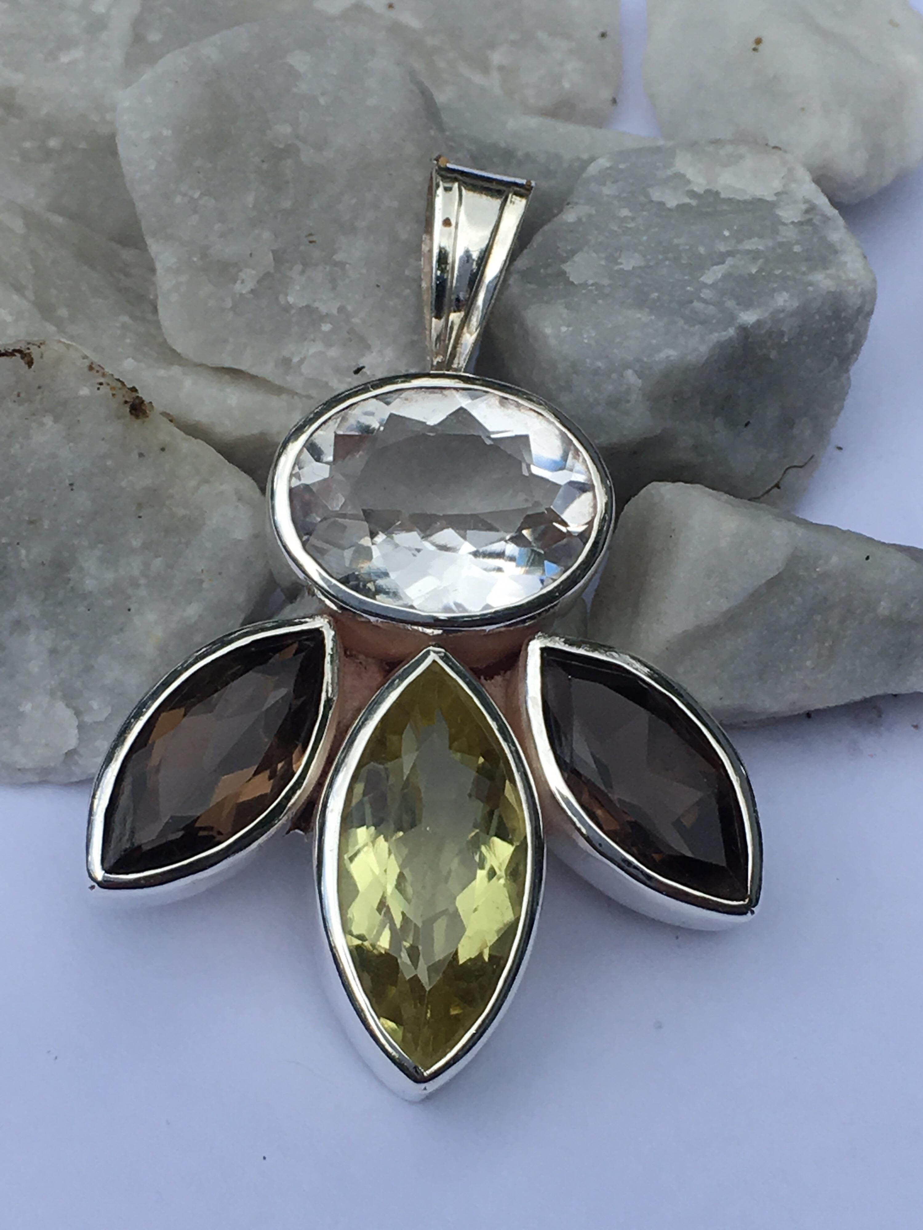 Marquise Lemon Quartz 10 MM X 20 MM, Smokey Quartz 8 MM X 16 MM and Oval Crystal 12 MM X 16 MM .
Hand cut and polished stone and one of a kind hand  crafted pendant.
Pendant measures 34 MM .
Total pendant is 17.81 Gram.
One can wear this pendant