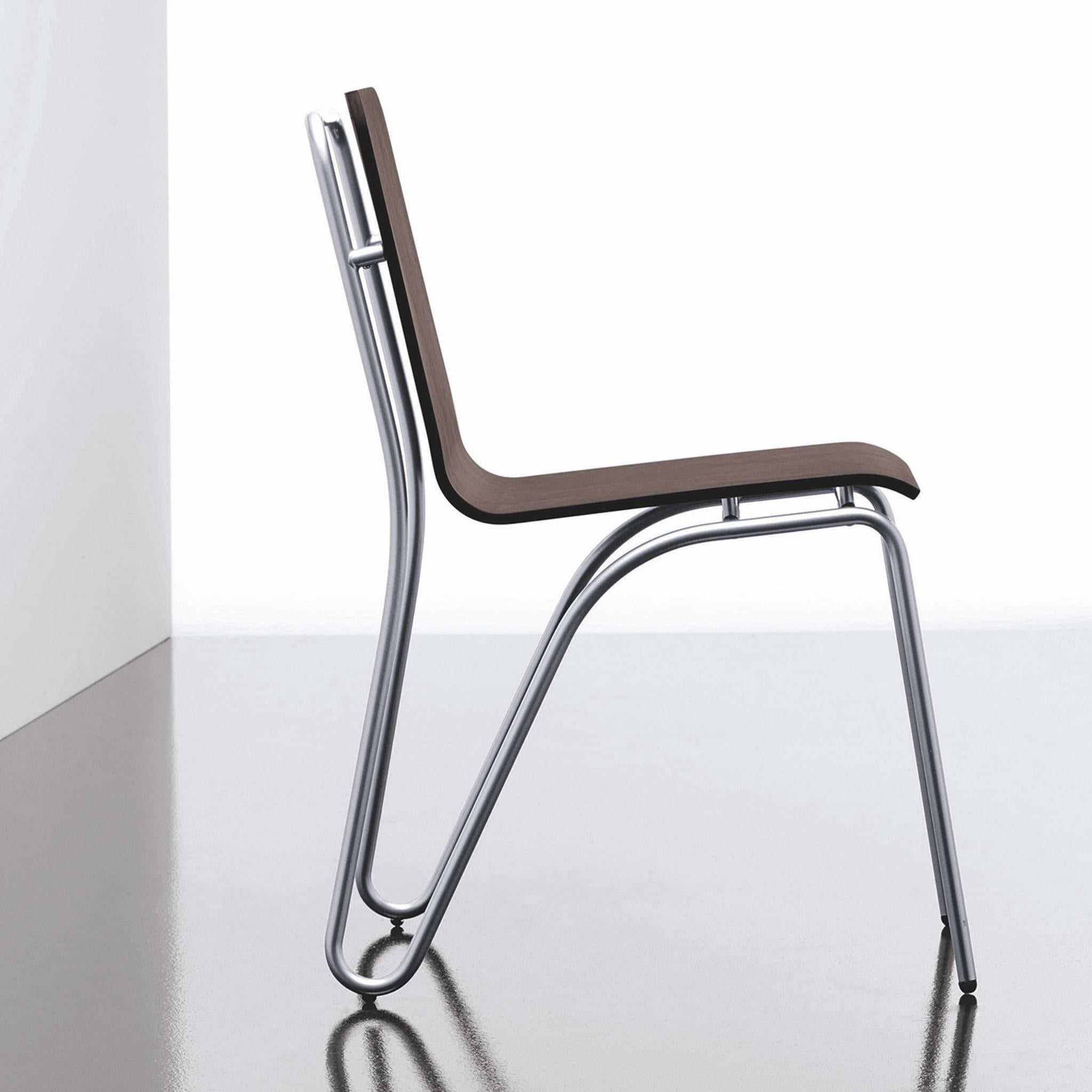 This chair's extremely unique frame is made from seamless, bent, steel tubing with a satin chrome finish. Its beech plywood shell sports a black-oak veneer. This item's silhouette is dynamic, yet sturdy. It is also available in a selection of