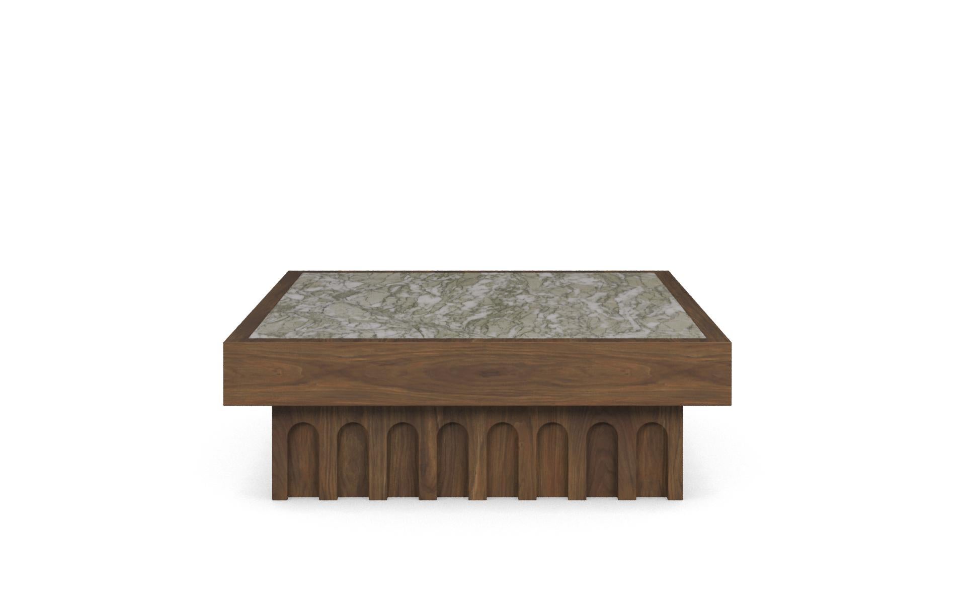 La table basse Léna est une table basse en marbre vert de Perse, conçue comme un volume sculptural carré qui ancre les zones d'assise avec une présence mesurée. Sa clarté géométrique équilibre la forme et le matériau. La pièce se présente sous la