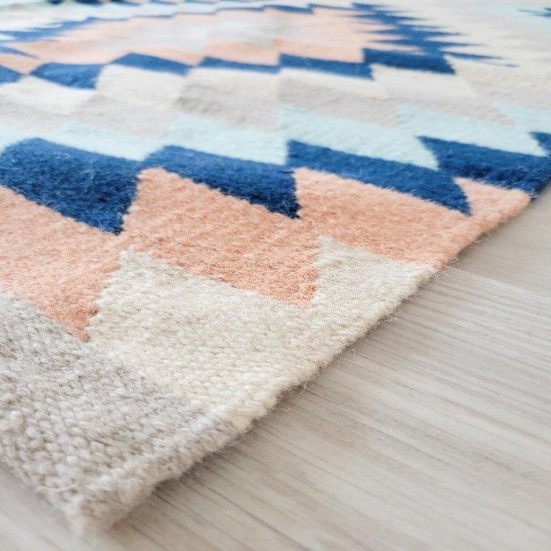 This pale peach, mint, and navy blended rug is a stunning and unique way to elevate any room. The soft and delicate tones of pale peach combined with the freshness of mint and the depth of navy create a beautiful and harmonious finish. 

Product