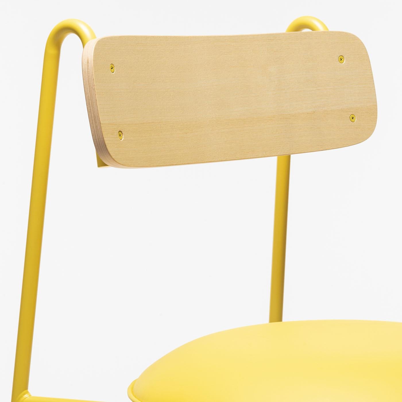 Yellow powder-coated metal frame with a natural polished ash veneered backrest and upholstered seat in yellow eco-leather.The Lena beautifully merges playful minimalism with graphic design influence, creating a captivating harmony between style and