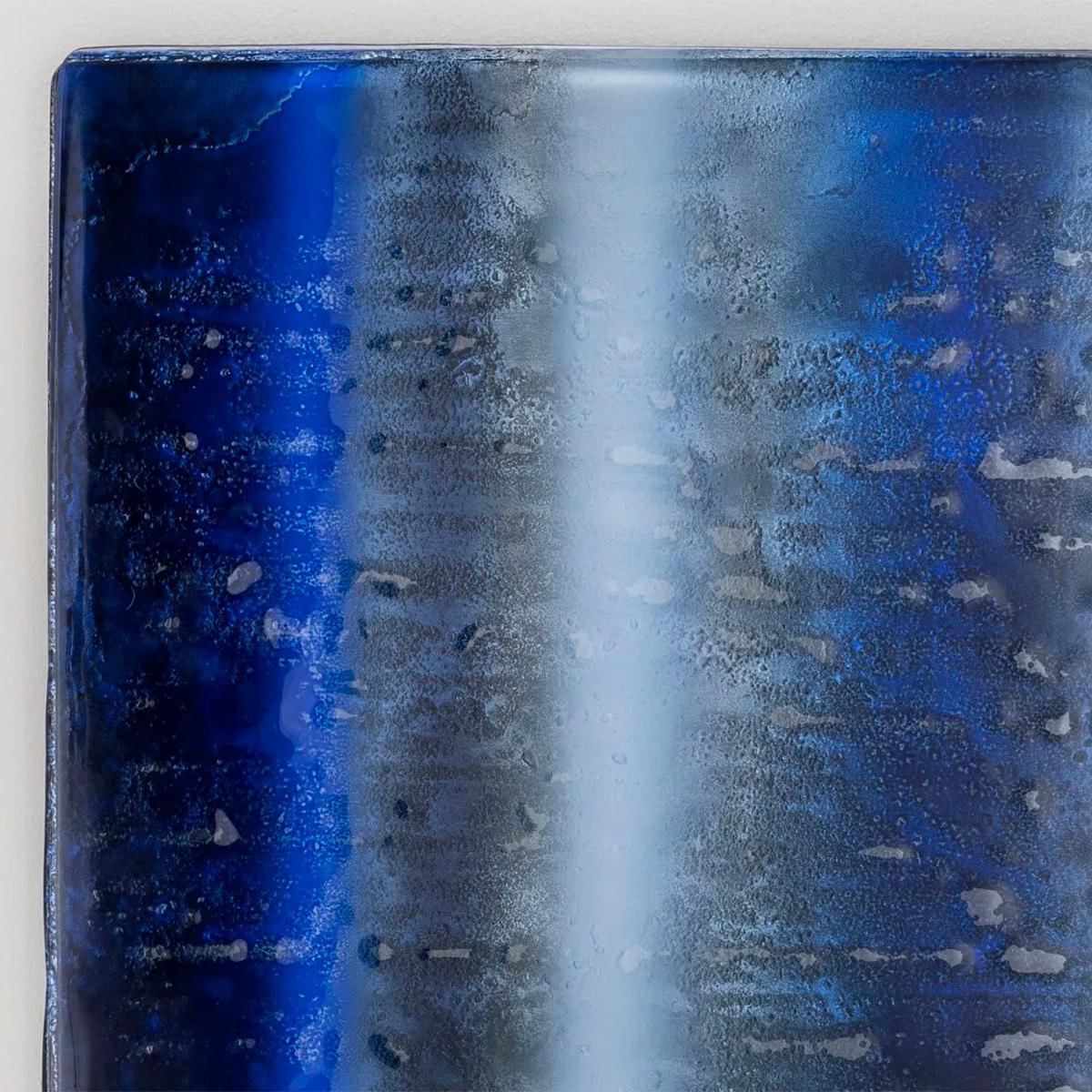Wall decoration Lenero Square in 2 layers baked glass with
irregular edges with gradients from dark deep blue two clearer 
intense blue with back silvered in medium antique finish. With
wooden frame at the back in black lacquered finish with