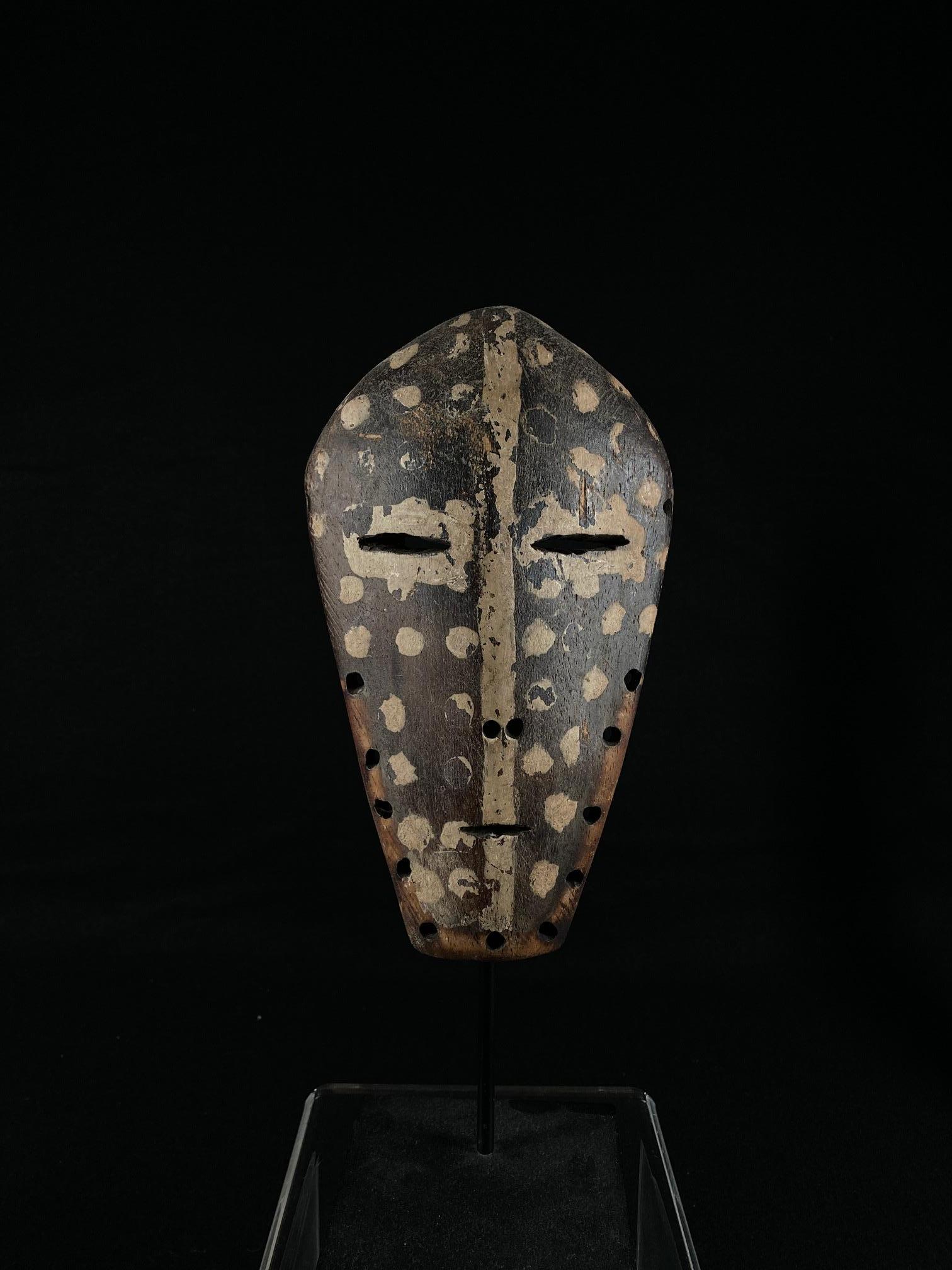 Lengola mask adorned with natural pigment, from Democratic Republic of the Congo, Africa. Ex California private collection. Mounted on a custom metal display stand.