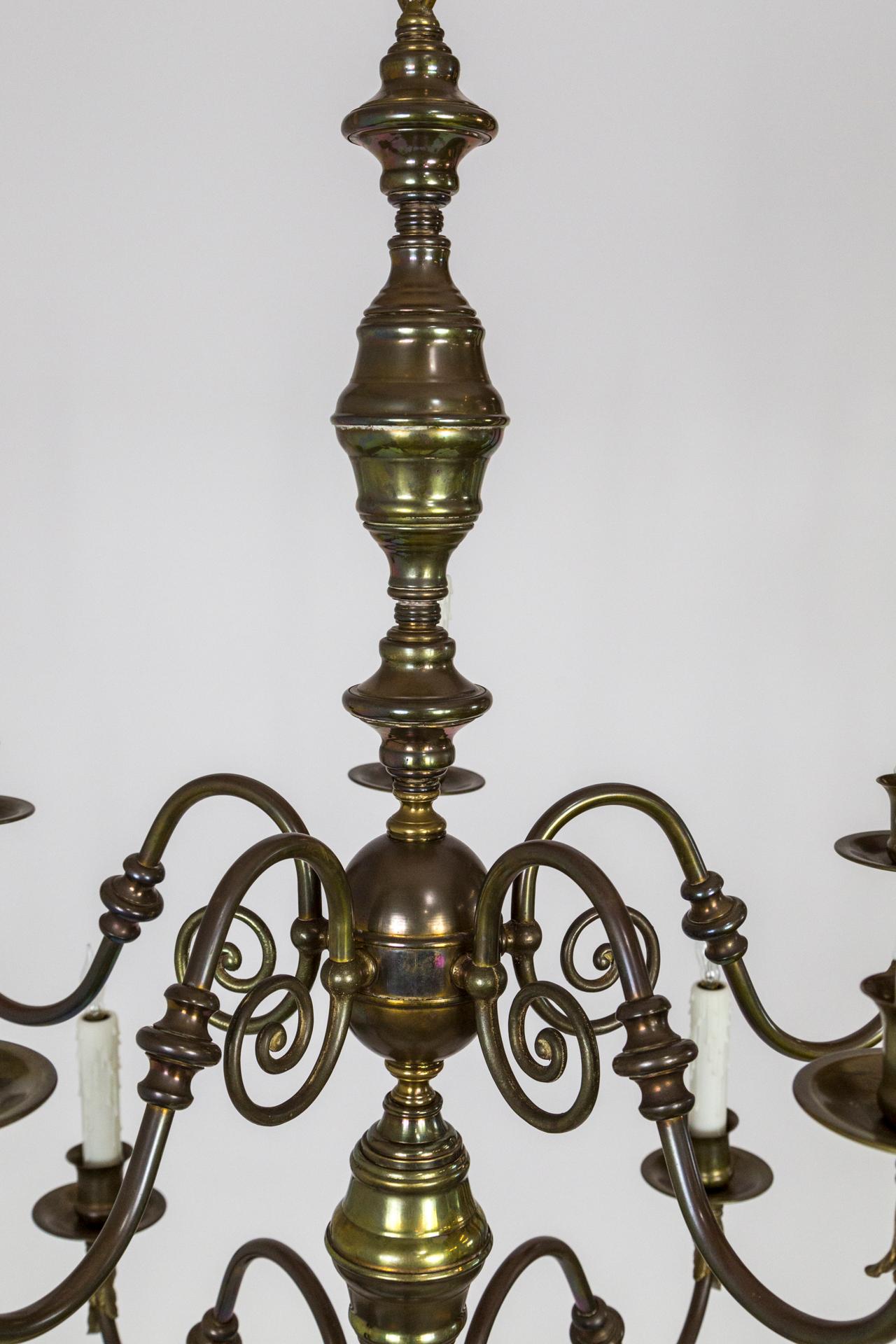 A spacious, Dutch Baroque style, 10-arm, brass chandelier with lovely decorative scroll work and acanthus leaf accents under the bobeches, and a well proportioned, large bottom ball. With a pleasing patina with areas of subtle iridescence.