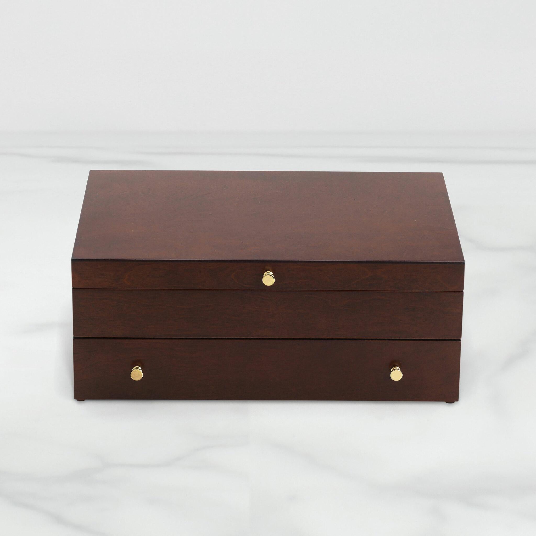 Easily store your favorite utensils with this beautiful flatware chest crafted in smooth mahogany wood. Lift the lid to unveil two sections: a top section to tuck in steak knives and a bottom section that separates out spoons, forks and more. Pull