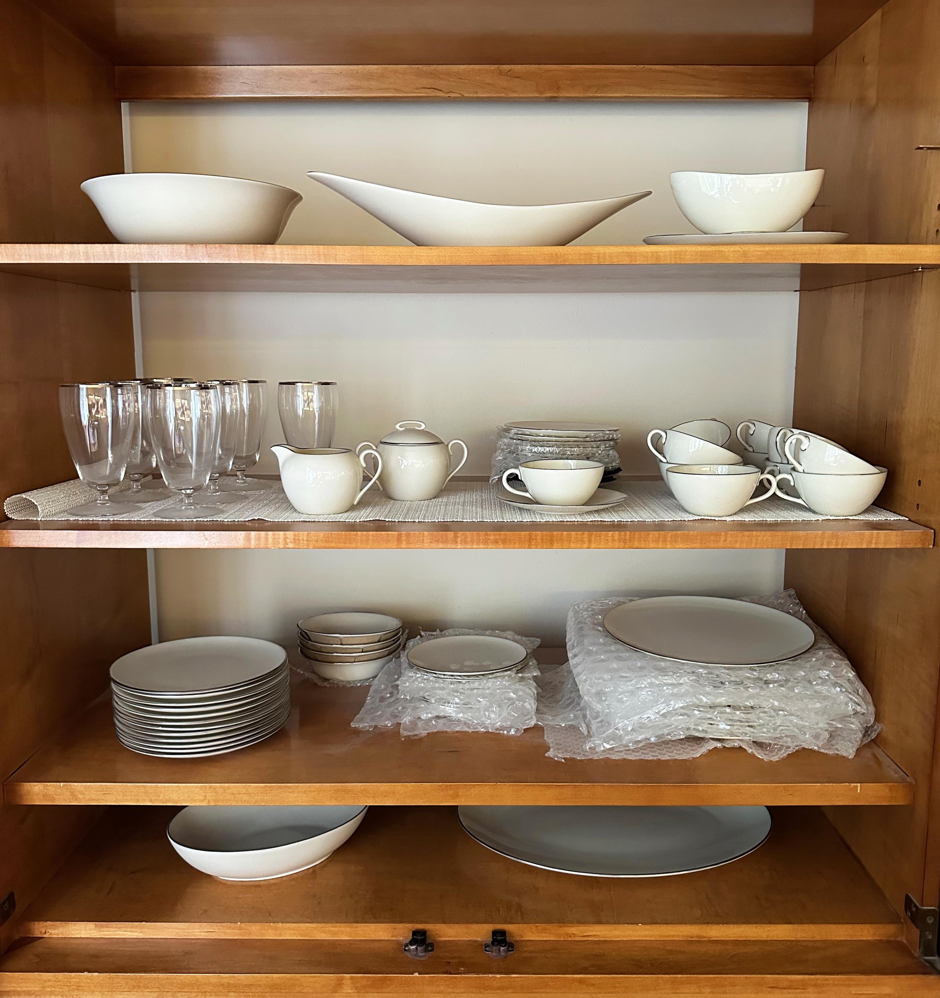 The essence of elegant simplicity, this is a truly beautiful set of Lenox Olympia X-303P Platinum Rim bone china. Single estate, 1962. Exquisite condition. Signed.

7 Fostoria platinum rim water goblets also included. Purchased in 1962 to accompany