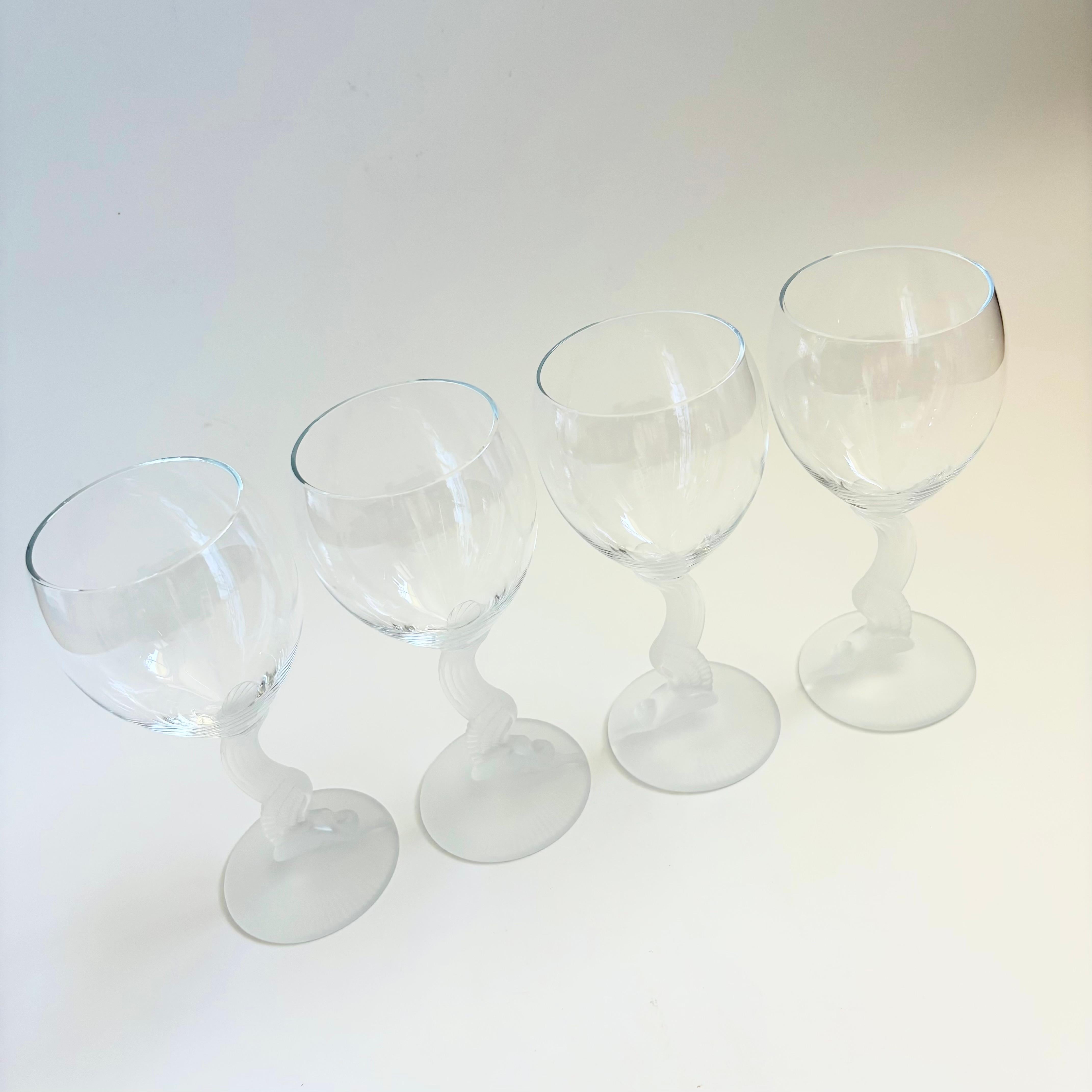 A set of 4 vintage wine glasses in the Swan Lake pattern by Lenox. Beautiful frosted stems in the shape of a winged woman with clear bowls on top.

