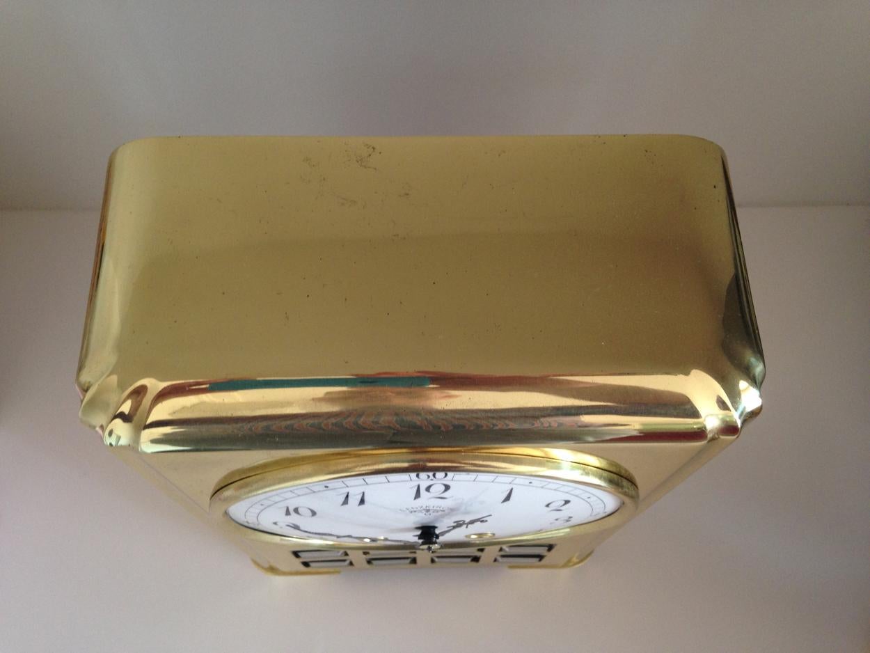 A rare Lenzkirch AGU 1 million Art Deco brass clock. Movement number 694724, circa 1920. 

The brass case with reeded corners, wooden caseback and eight square beveled glass windows set below the white dial with black hour and minute hands, Arabic