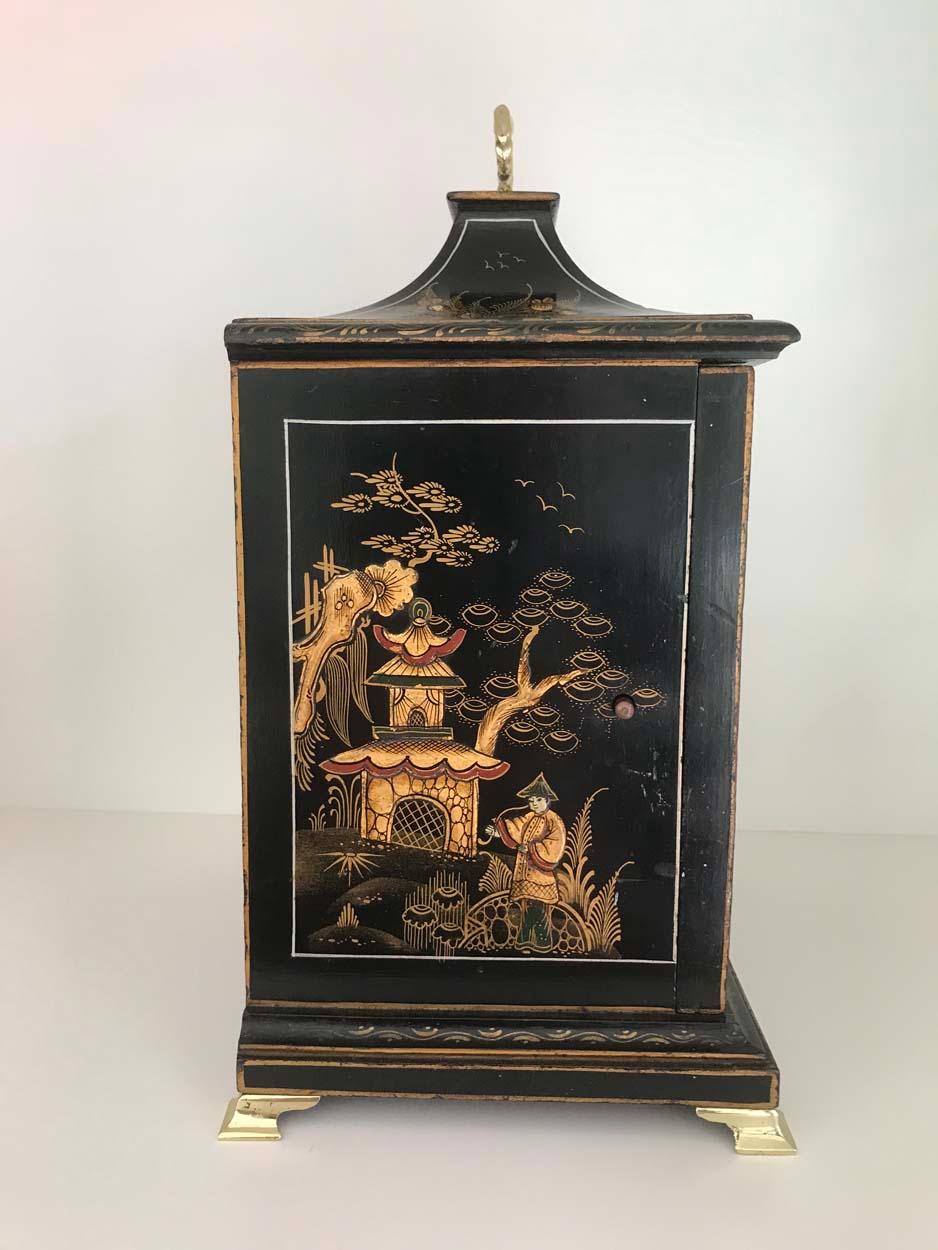 A beautiful and rare Lenzkirch three train musical mantel clock of Georgian style. The case profusely decorated with Chinoiserie scenes including people, pagodas, trees, birds and flowers, surmounted with a brass carry handle and mounted on brass
