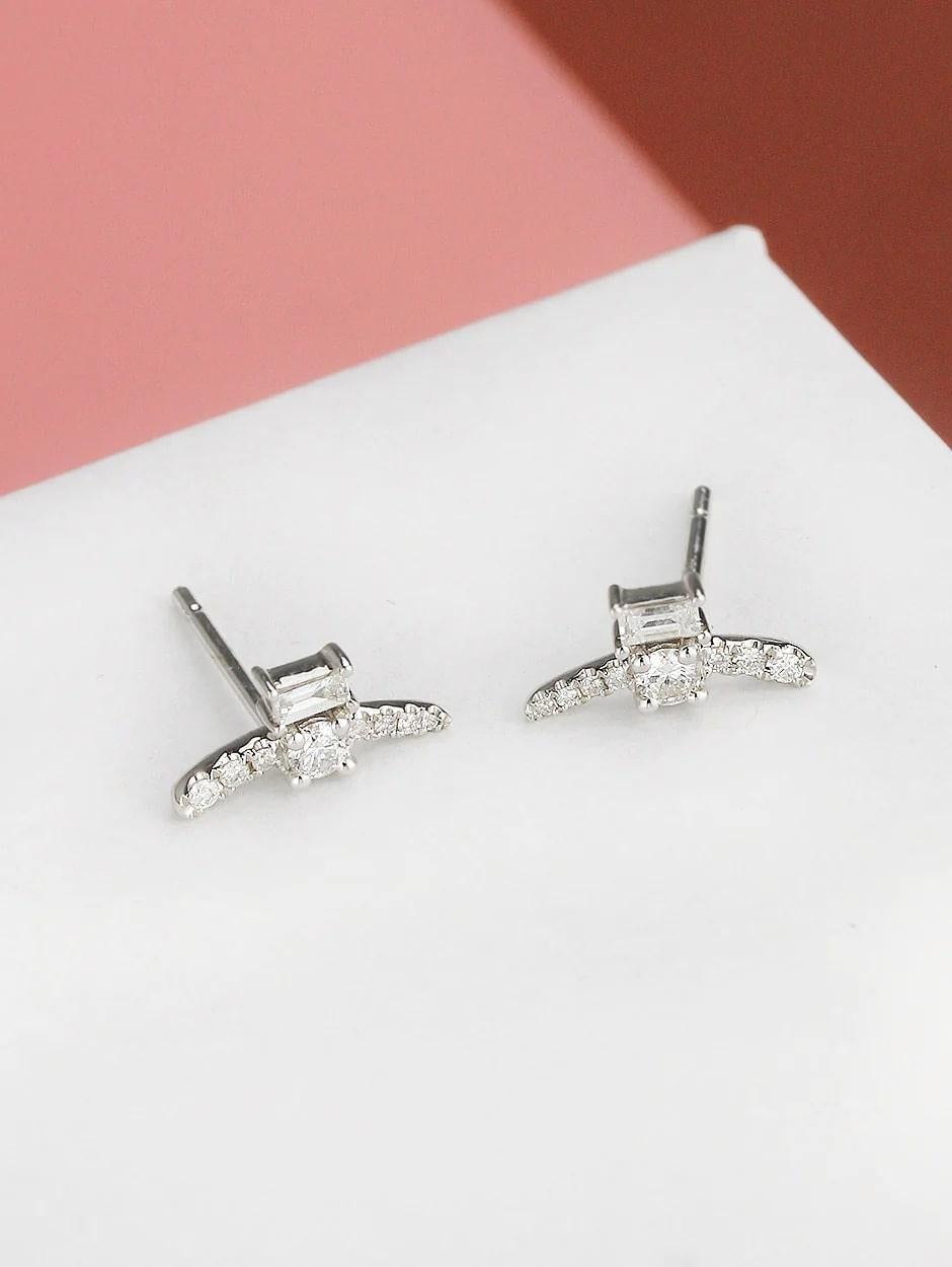 Combination of micro pave and baguette white diamond cuff earring, all with a high polish finish. Available in 18K White Gold.

Earring Information
Diamond Type : Natural Diamond
Metal : 18K
Metal Color : White Gold
Diamond Carat Weight :
