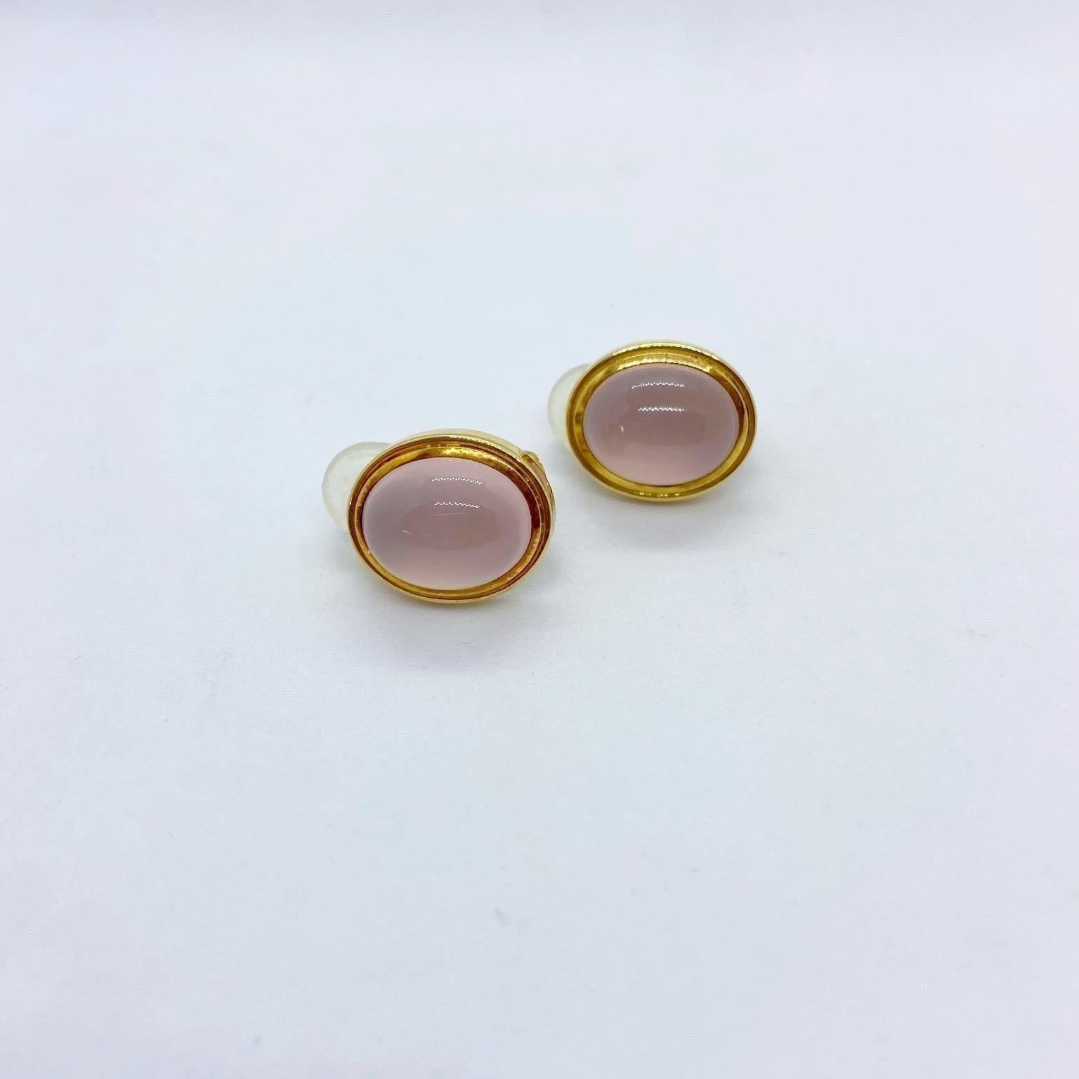 Started in 1967 by Leo and Ginnie de Vroomen the company is known for bold and innovative designs. Distinctive from the start, the renowned company is simply known as de Vroomen.
These 18 karat yellow gold earrings feature oval rose quartz cabochon