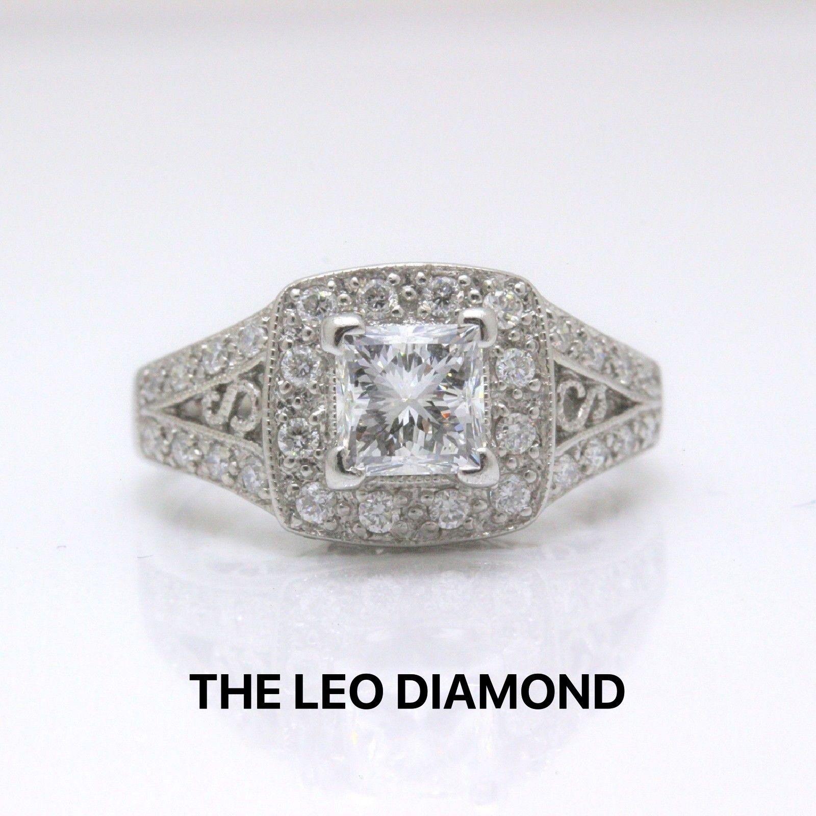 THE LEO DIAMOND
Style:  Solitaire set in Diamond Pave Engagement Ring
Serial Number:  LEO-61404S
Metal: 14KT White Gold
Size:  5.25 - sizable
Total Carat Weight:  1.32 TCW
Diamond Shape:  Leo Princess Cut
Center Stone Weight: 0.98 CTS
Diamond Color