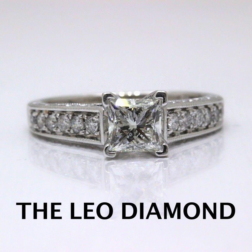 THE LEO DIAMOND PRINCESS CUT IN VINTAGE INSPIRED DIAMOND ENGAGEMENT BAND
Style:  Solitaire with Diamond Accented Band
Serial Number:  LEO 5090869S
Metal: 14KT White Gold
Size:  6 - Sizable
Total Carat Weight:  1.48 TCW
Diamond Shape:  Leo Princess