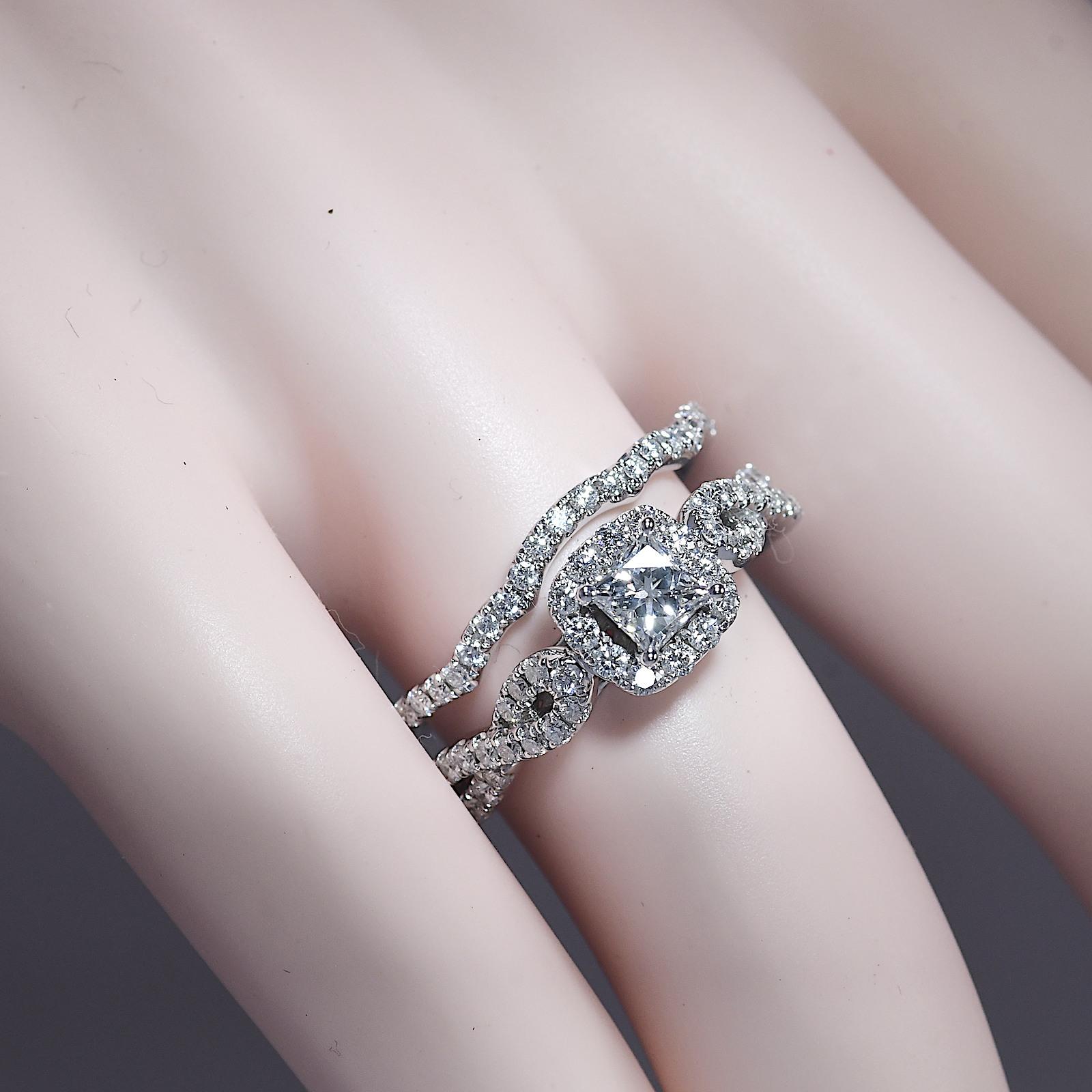 A scintillating .45 carat princess-cut Leo Diamond is the focal point of this elegant engagement ring for her. Shimmering round diamonds frame the center and flow along the 14K white gold band and the matching wedding band, bringing the total