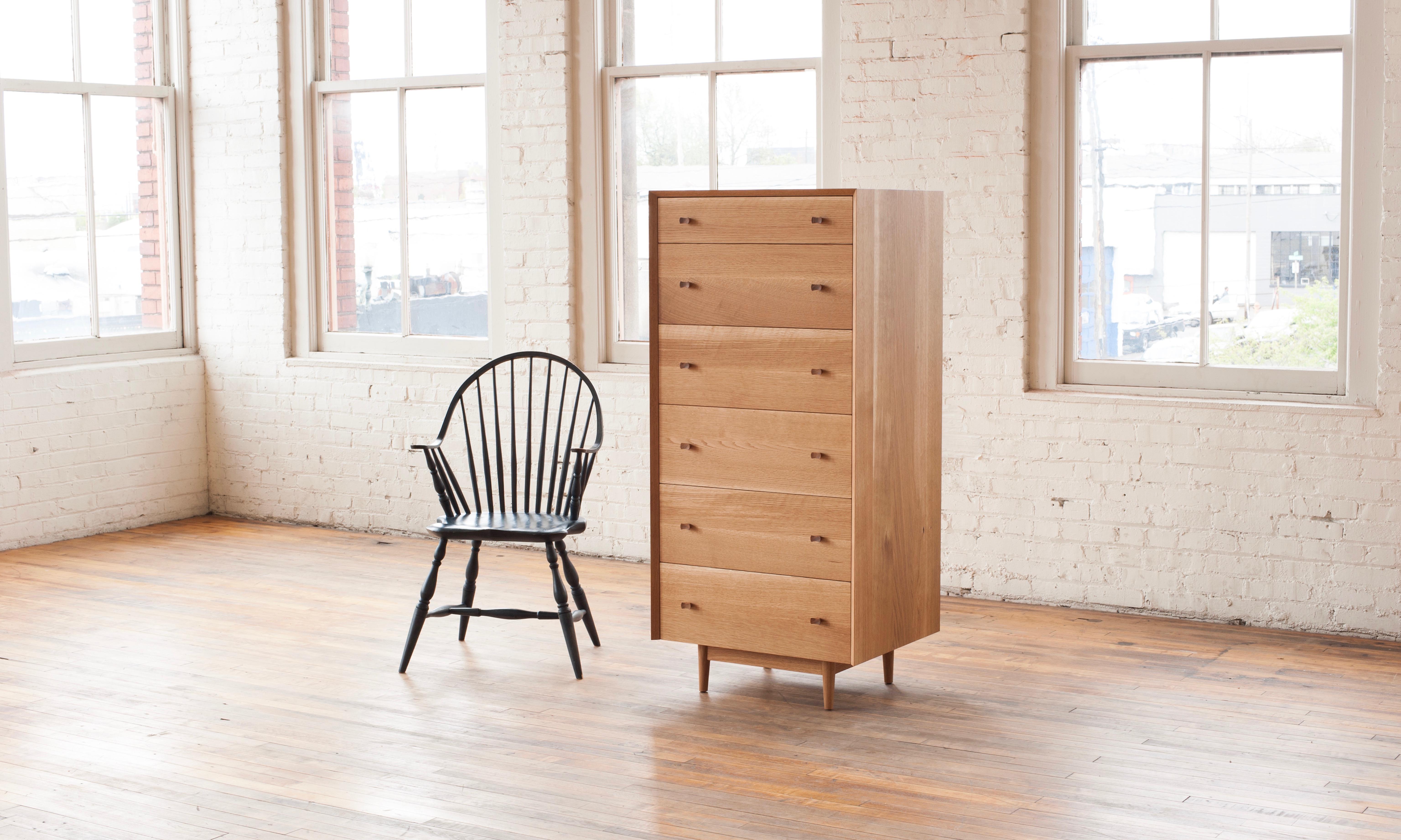 The Leo Highboy is contemporary take on a traditional highboy. The hardwood case has a continuous grain match waterfall miter from side to top to side. 6 solid maple drawer boxes slide easily with self closing slides. The flume knobs are turned on a