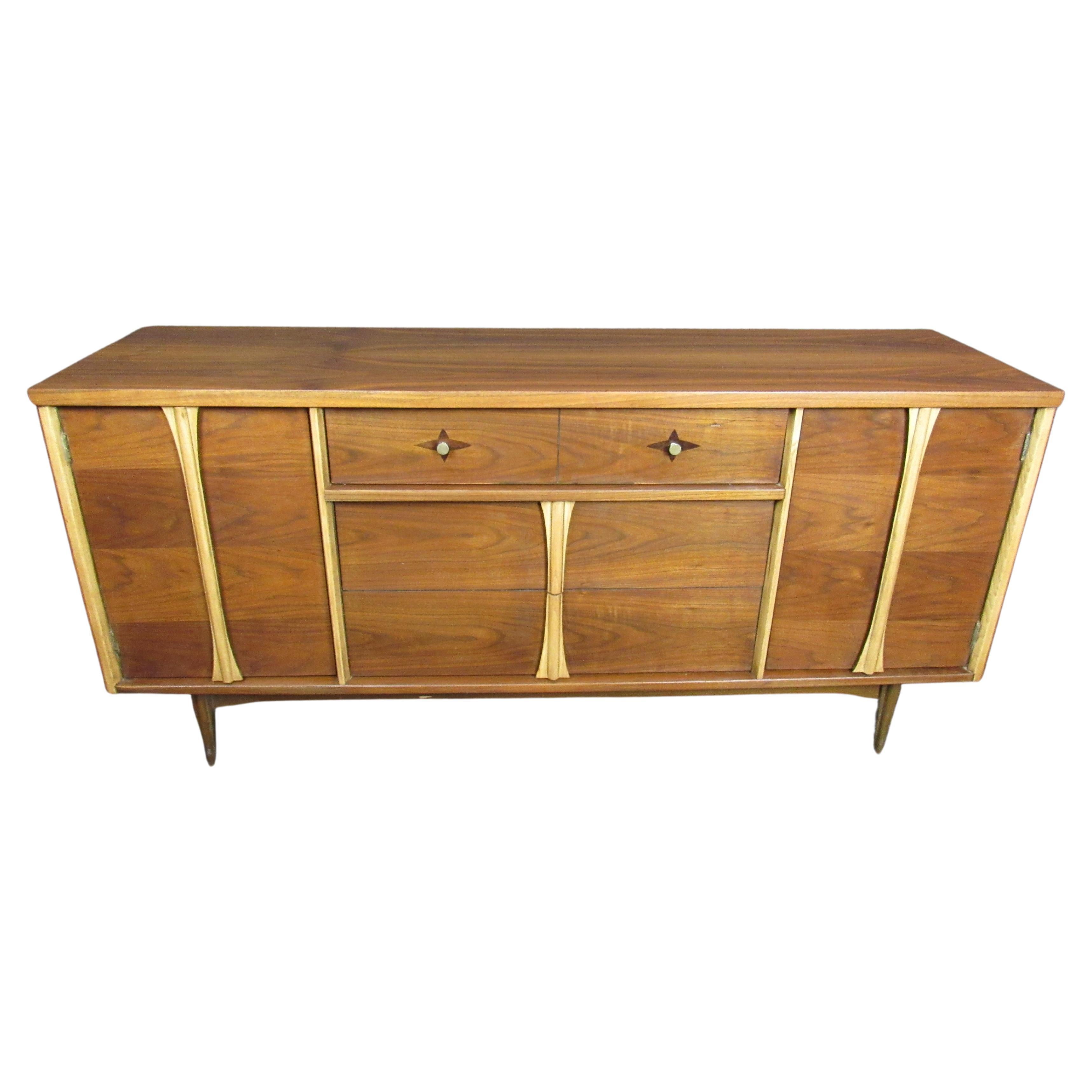 Mid-Century Modern long dresser designed by Leo Jiranek for Bassett Furniture. Made for the Context Collection, featuring offsetting woods and tones. Warm, walnut grain with oak trim and rosewood inlay diamonds. 
Please confirm location.