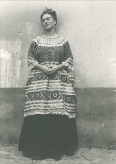 Untitled (Frida Kahlo standing against concrete wall)