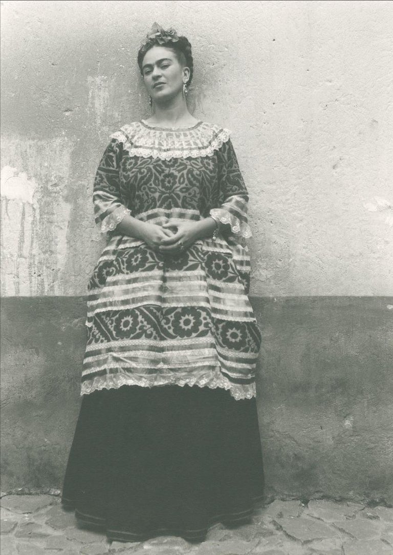 Leo Matiz Portrait Photograph - Untitled (Frida Kahlo standing against concrete wall)