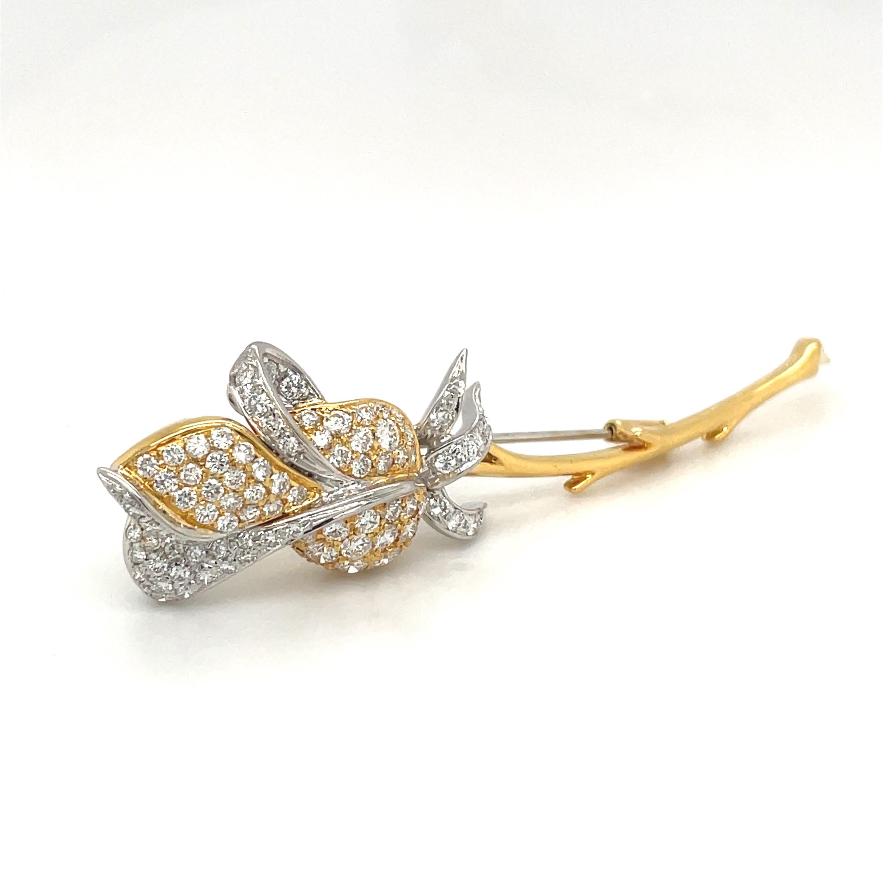 Designed in Italy by Leo Pizzo, this 18 karat yellow and white gold brooch is beautifully designed to depict a very graceful rose. The round brilliant diamonds are set in the combination of golds, giving depth to the elegant rose. The brooch