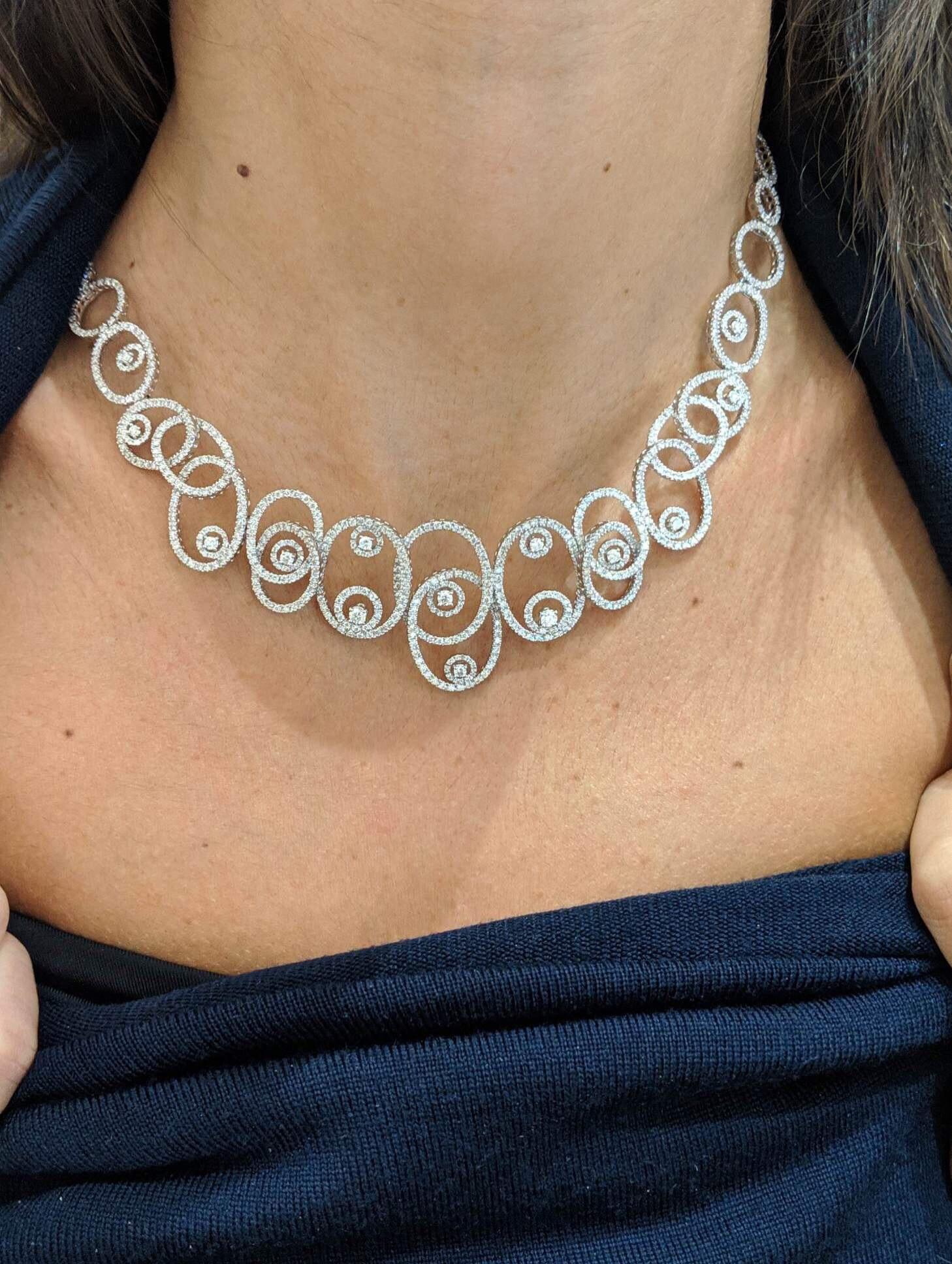 Leo Pizzo graduating  oval swirl motif necklace composed of 6.18 carats of micro-pave and round brilliant diamonds. The diamonds stop halfway around at which point the necklace is set in alternating sizes of 18 karat white gold circles. 
The piece