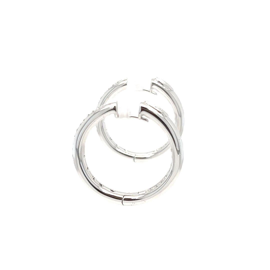 Leo Pizzo 18 Karat White Gold Diamond Hoop Earrings with 3.8mm Tube Design. 56 Round Brilliant Cut Diamonds of VS Clarity and G Color Total Approximately 0.56 Carats. 24mm Inside Diameter. Pierced Post with Hinged Clip Back. Finished Weight is 13.4