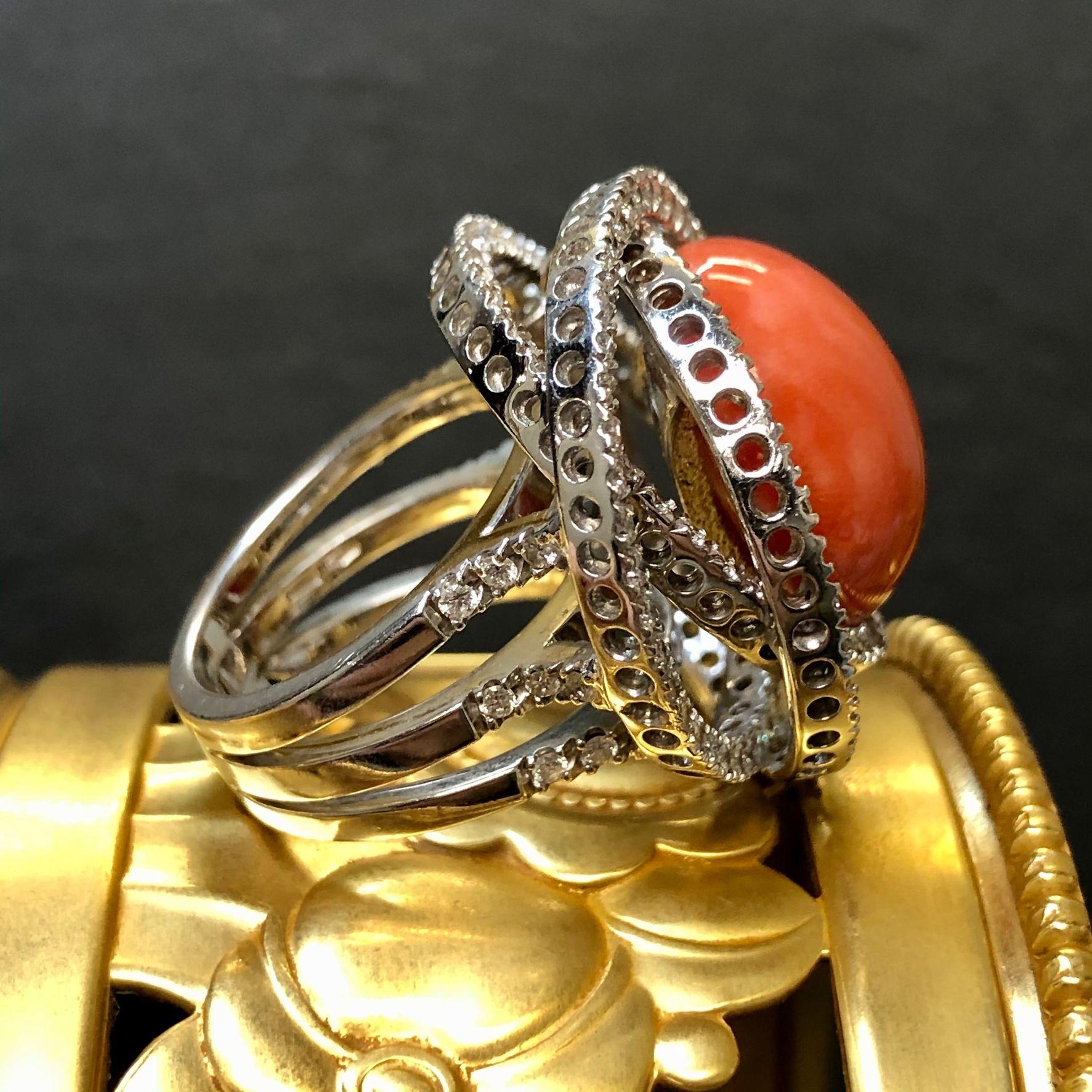 An exceptionally crafted ring by famed Italian designer LEO PIZZO. This ring is crafted in 18K white gold and centered by a a beautiful piece of natural red coral surrounded by approximately 2.90cttw in G-H color Vs1-2 clarity