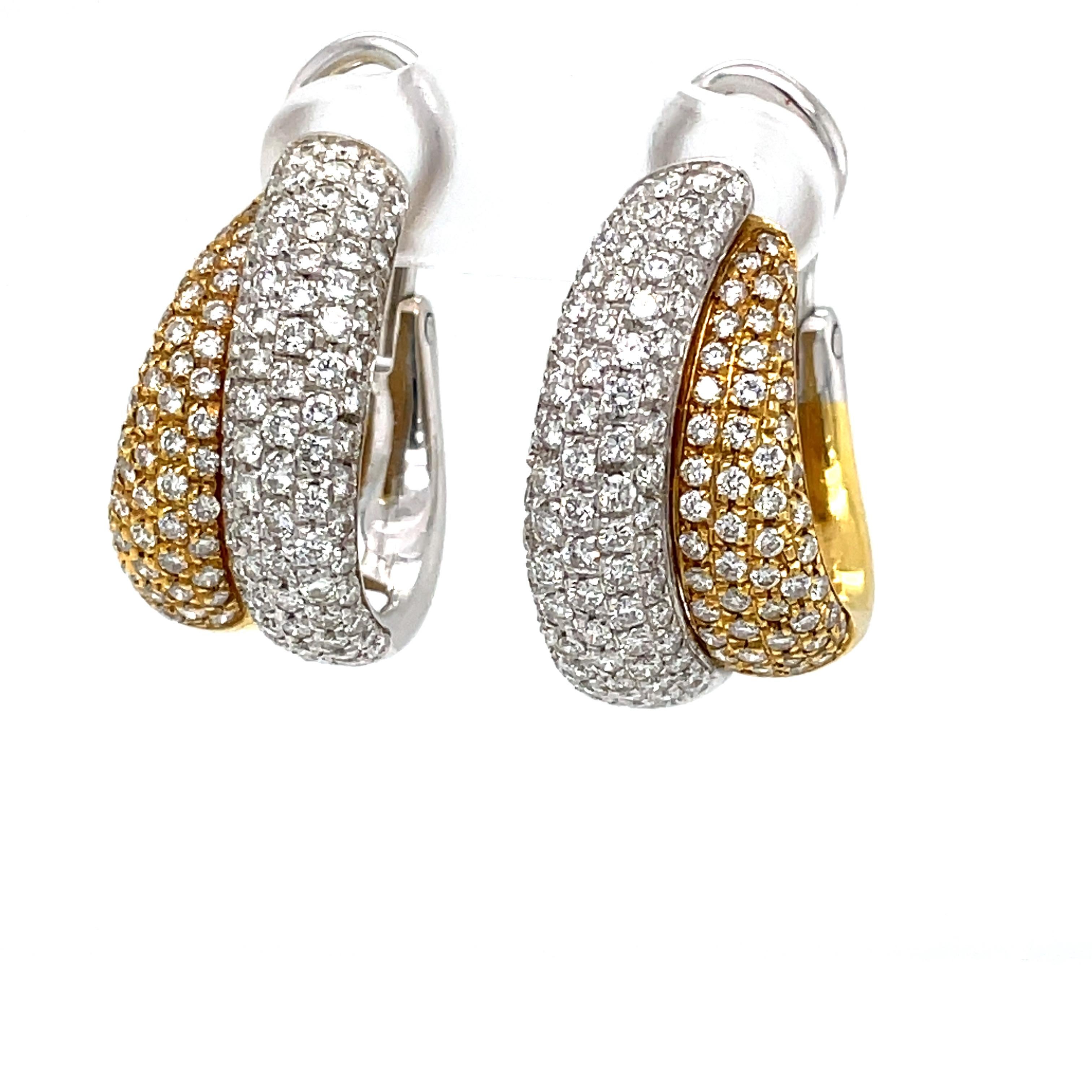 By noted Italian designer Leo Pizzo of Milan, a sensational classic double hoop earring pair in eighteen karat 18K white and yellow gold encrusted with over three carats total weight of round full cut faceted diamonds. The Pizzo ethos incorporates