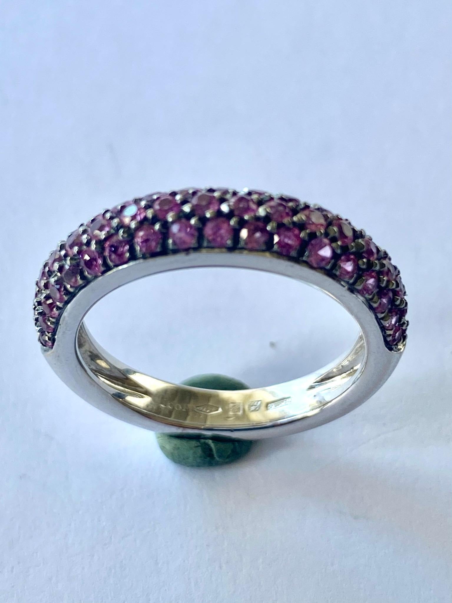 One (1) 18K. Karat White Gold Ring, Stamped 750 and Leo Pizzo  (Italy)  and [*2041 AL]
Set with Fifty Five (55) Round, mixed Cut Natural Pink Sapphires  Total weight: 1.07 ct.
Total Weight of the Ring: 5.76 grams.
Size of the Ring: 17.5 (55)  USA 