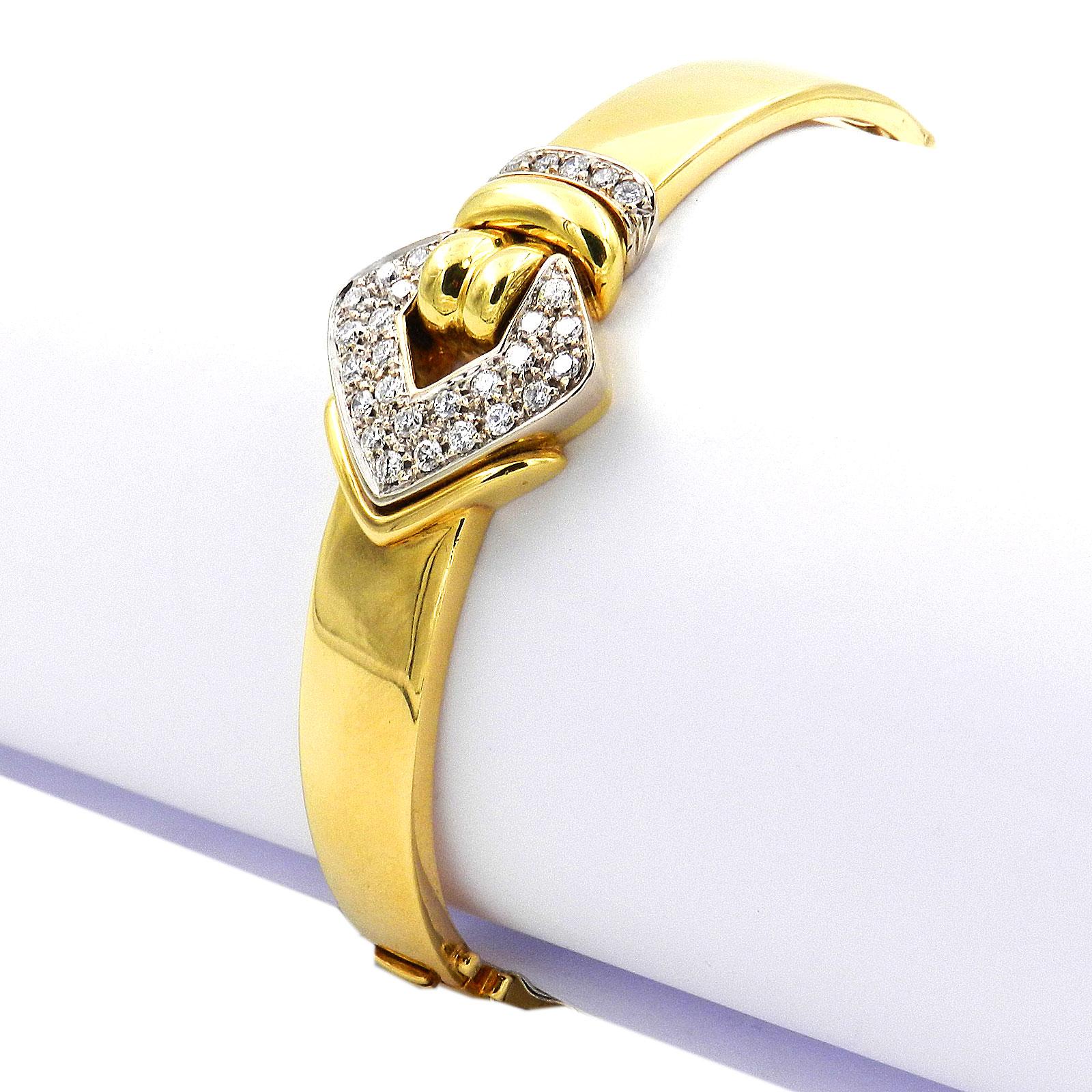 Leo Pizzo signed 0.9 Carat Diamond 18 K Gold Bangle Bracelet

Decorative bangle handmade in the italian jewelry manufacture Leo Pizzo from high-carat gold, set on the front with a white golden buckle motif and pave set with 29 sparkling