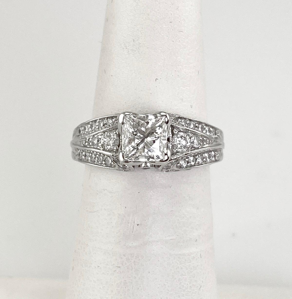 Women's diamond engagement ring consisting of .98 carat Leo princess cut center and round diamonds along the sides. The total diamond weight is 1.54 Ct. The mounting is 18 karat white gold. The center diamond is SI1; G and has the Leo serial number