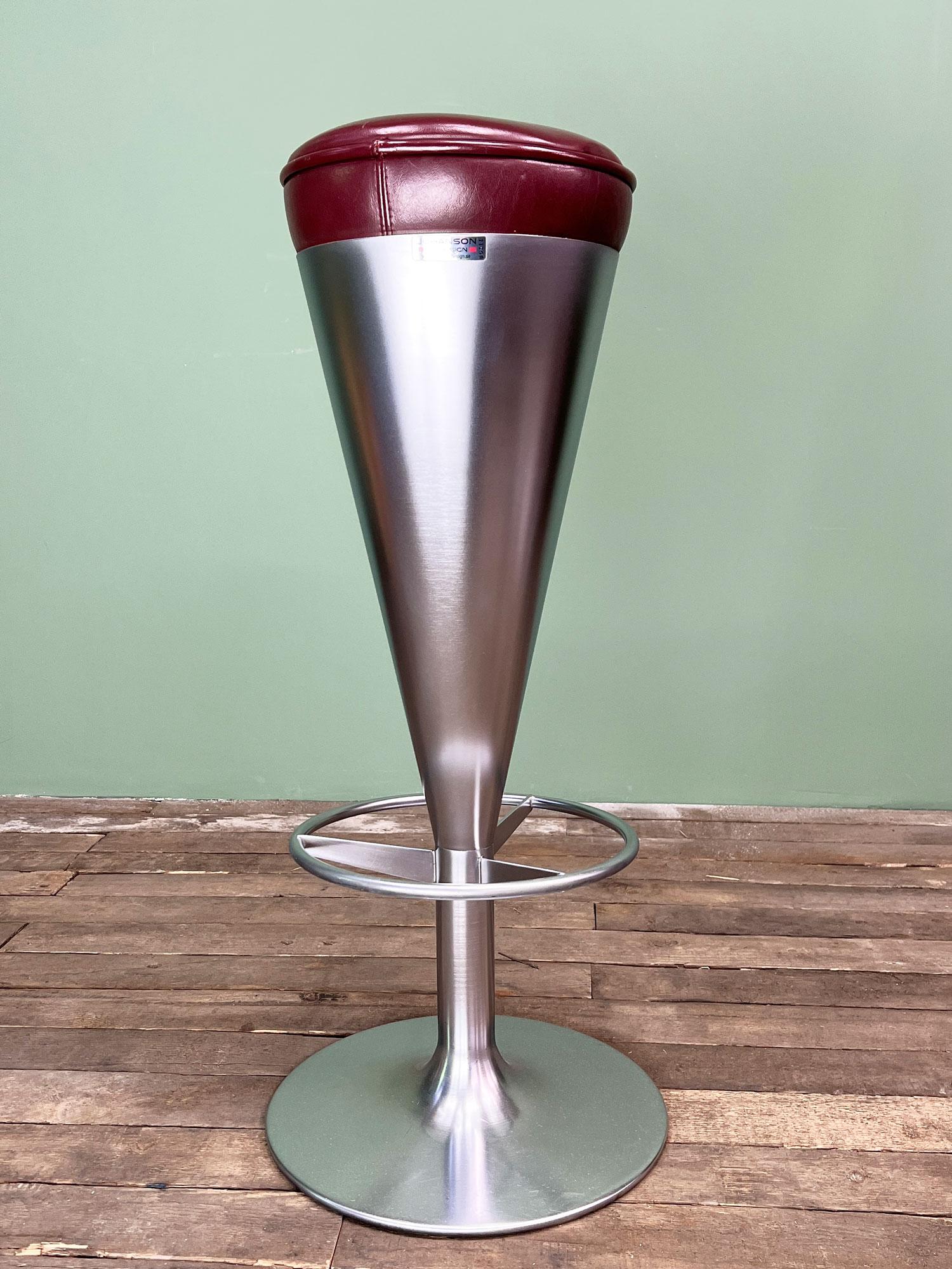 A set of four 1960's bar stools designed by Leo Thafvelin. Produced by Johanson Design in Markaryd, Sweden. 

Featuring a burgundy leather seat which is 27cm diameter on a stainless steel base which is 35cm at the bottom. 

All four of these stools