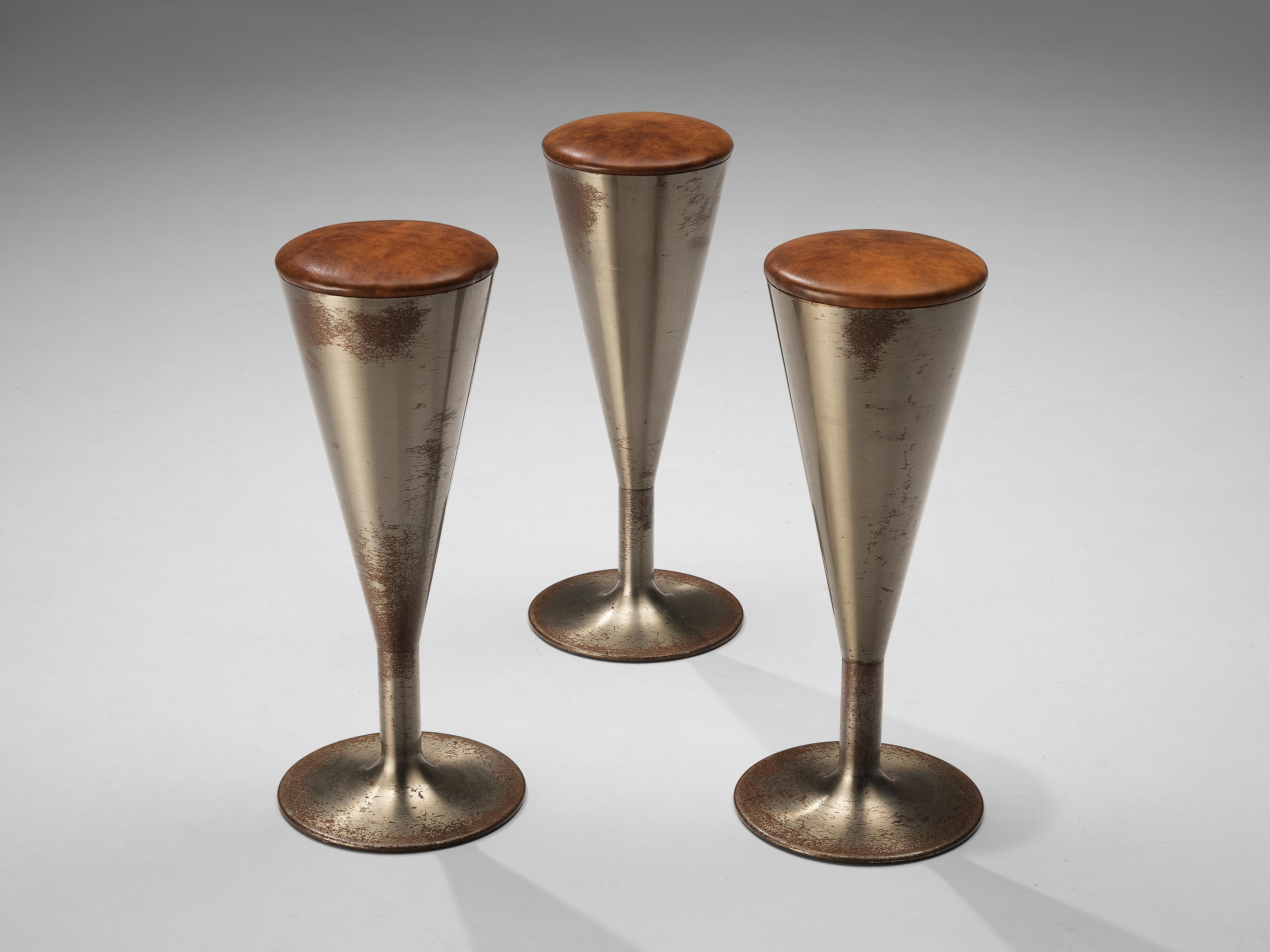 Leo Thafvelin for Johanson design, set of three bar stools, patinated steel, leather, Sweden, 1960s 

This eccentric set of three bar stools is designed by the Swedish designer Leo Thafvelin. The stools are executed in a cognac leather for the