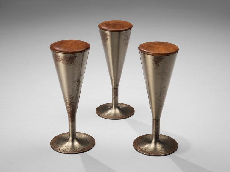 Leo Thafvelin for Johanson design, set of three bar stools, patinated steel, leather, Sweden, 1960s 

This eccentric set of three bar stools is designed by the Swedish designer Leo Thafvelin. The stools are executed in a cognac leather for the