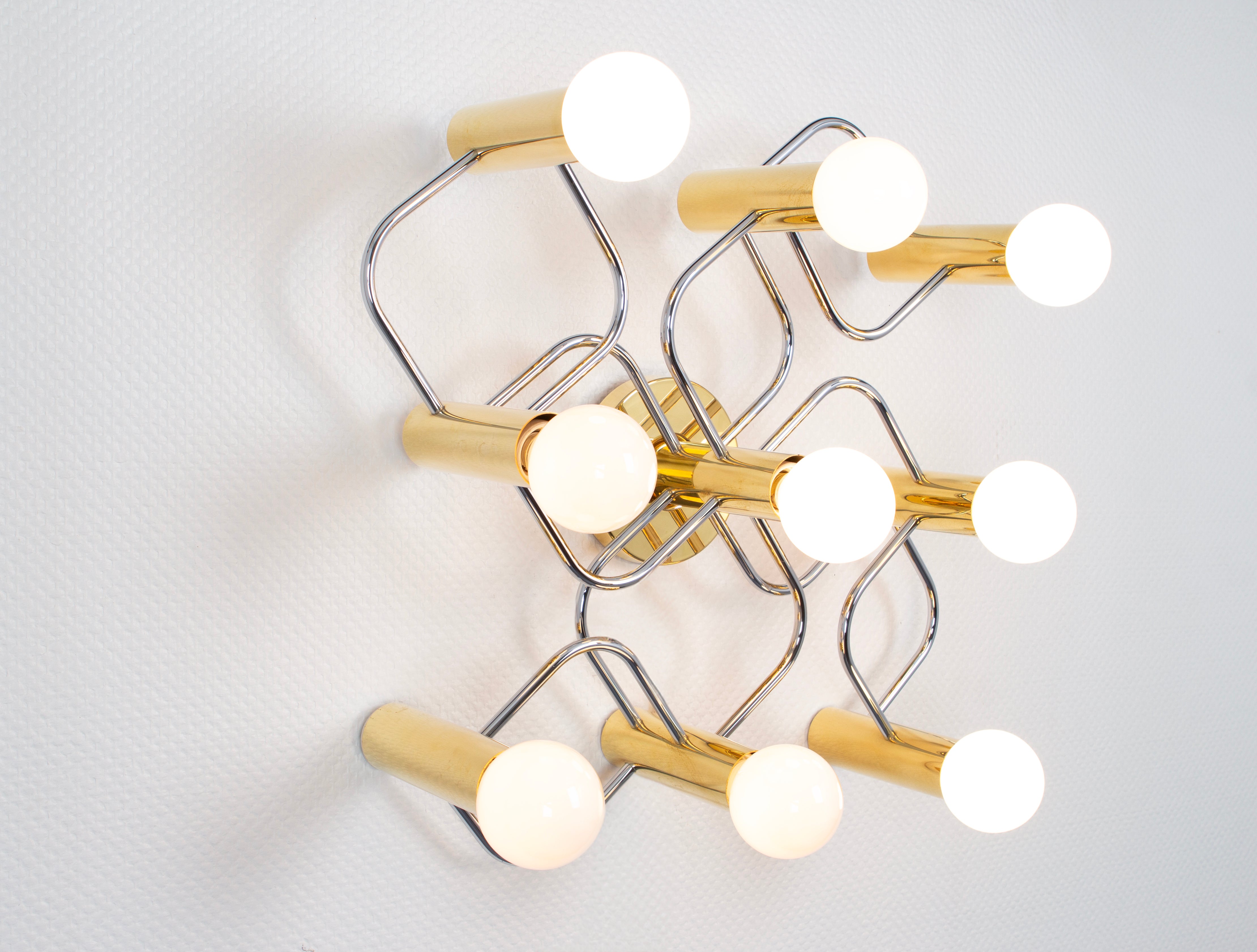 A stunning nine-light flush mount light fixture in brass and chrome can be used as a wall or ceiling light.
Design: Sciolari
Sockets: 9 x E27 Standard bulbs - max 80 watts each
Light bulbs are not included. It is possible to install this fixture in