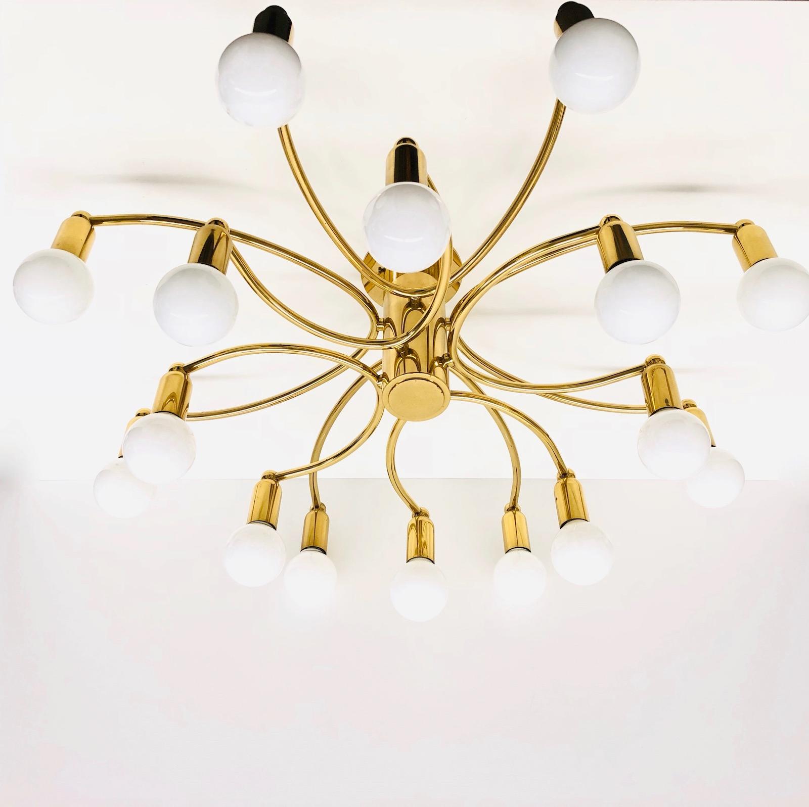 A gorgeous brass flush mount by Leola Leuchten. It can be used also as a sconce. The light fixture requires sixteen European E14 candelabra bulbs, each up to 40 watts. It measures approx. 8