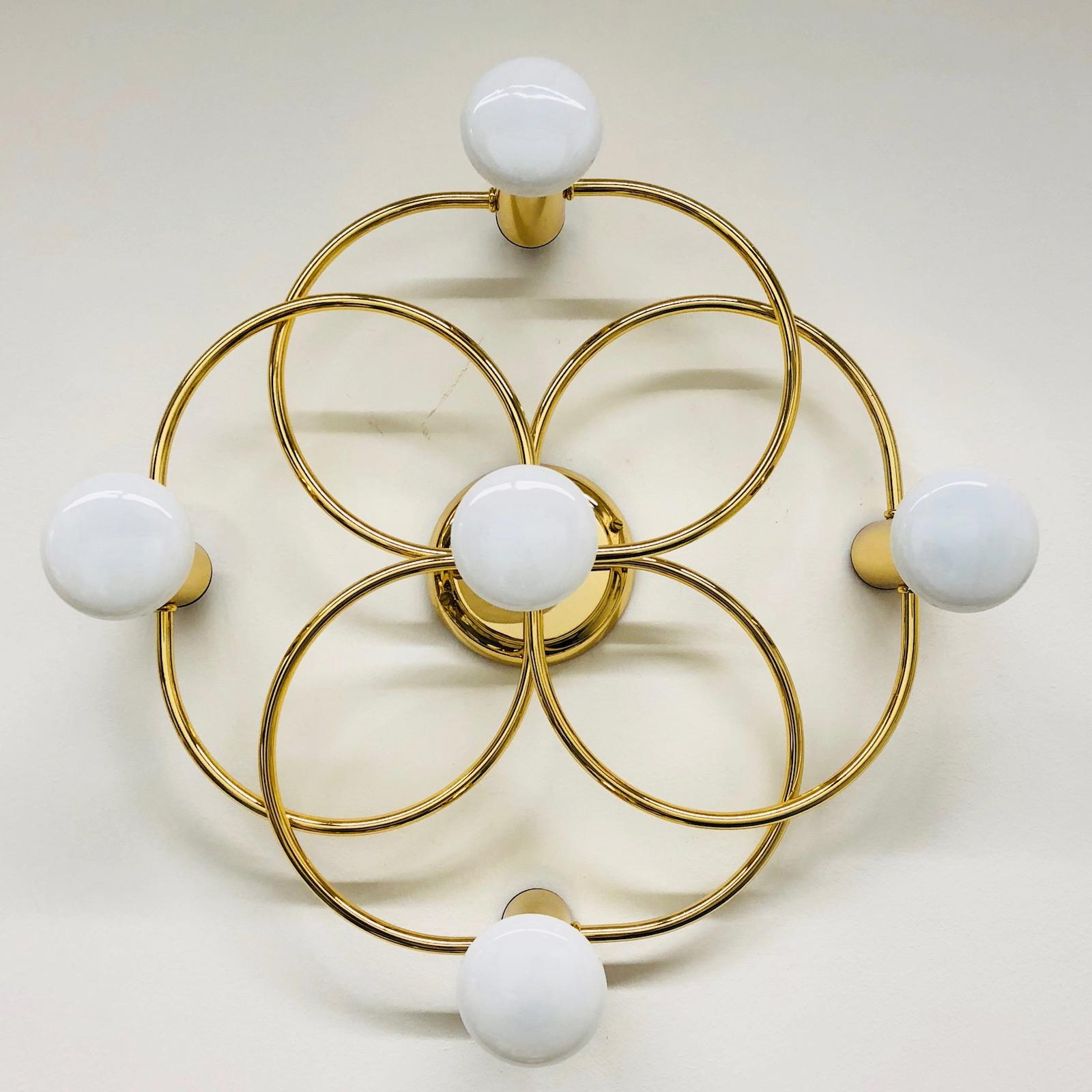 A gorgeous brass flush mount by Leola Leuchten. It can be used also as a sconce. The light fixture requires five European E14 candelabra bulbs, each up to 40 watts. It measures approx. 4 1/2