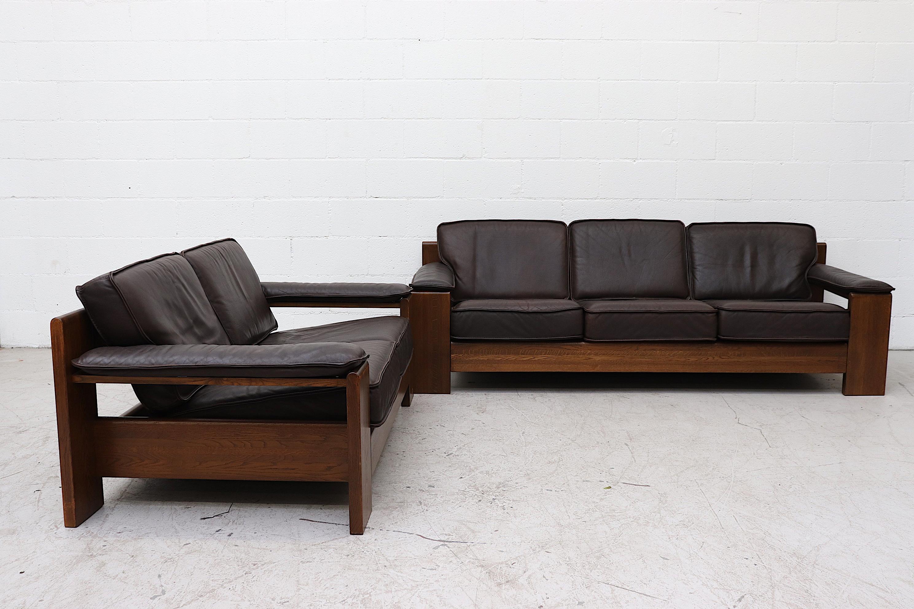 Amazing Dark Oak Framed Leolux 3 Seater Sofa with Beautifully Worn Espresso Leather Cushions. Armrests Snap On, a snap may be missing on one armrest. In Original Condition with Wear Consistent with its Age and Use. Shot with Matching Loveseat