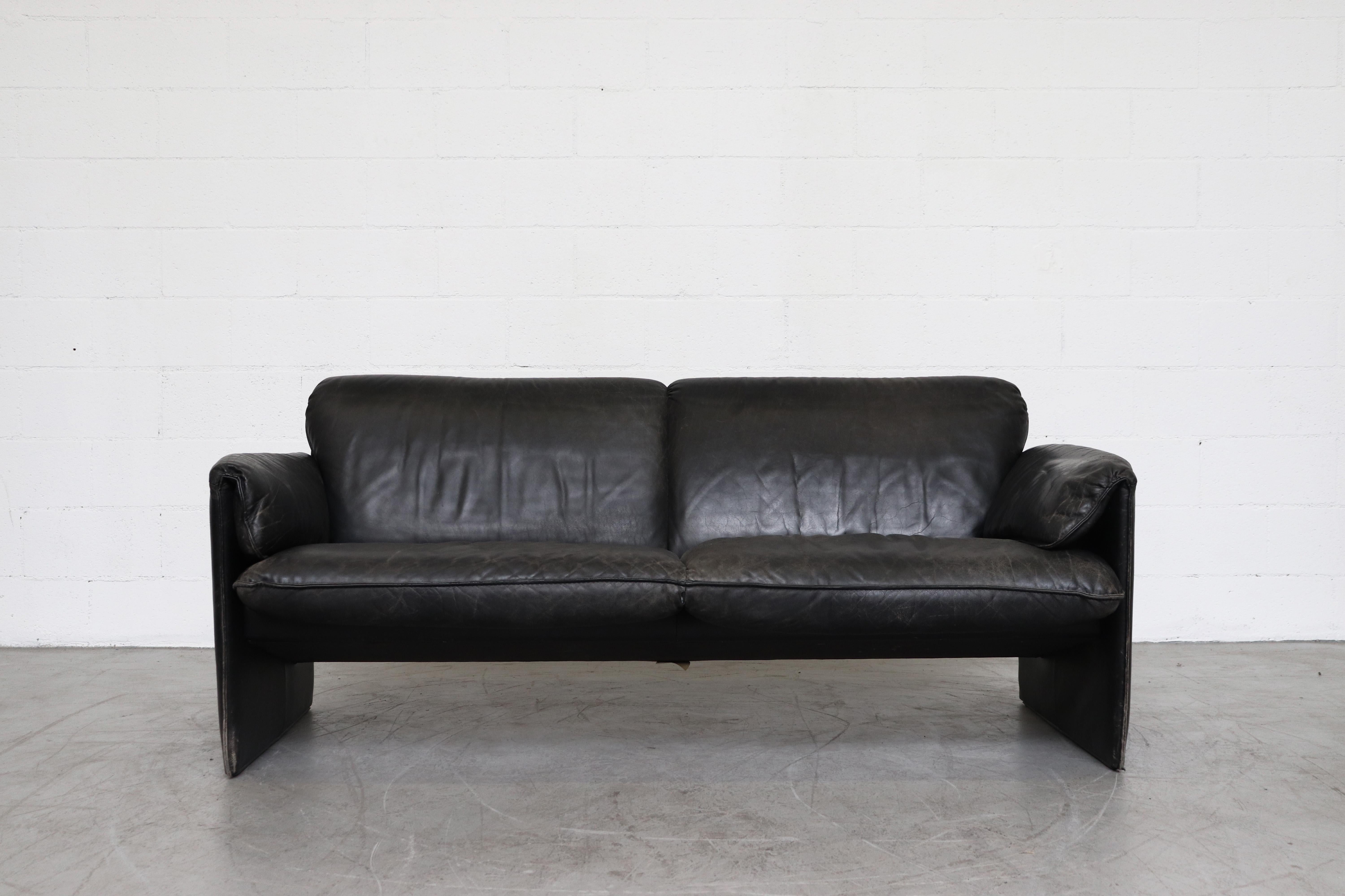 Handsome black leather 'Bora Bora' 2-seat sofa by Leolux. In original condition with visible wear and patina as detailed in pix. Two available is similar condition.