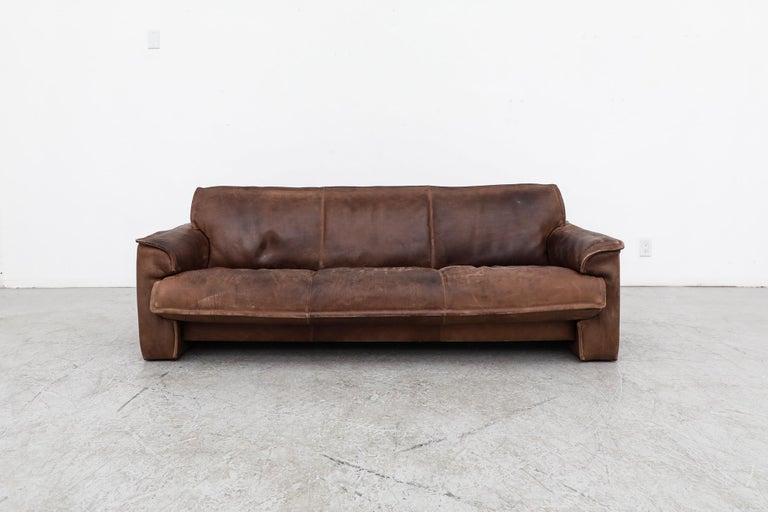Handsome Dutch 3 seater sofa with thick buffalo leather by Leolux. This hefty natural leather sofa is in very original condition. Well worn with heavy patina and wear consistent with its age and use. Some indentations in the leather from transport