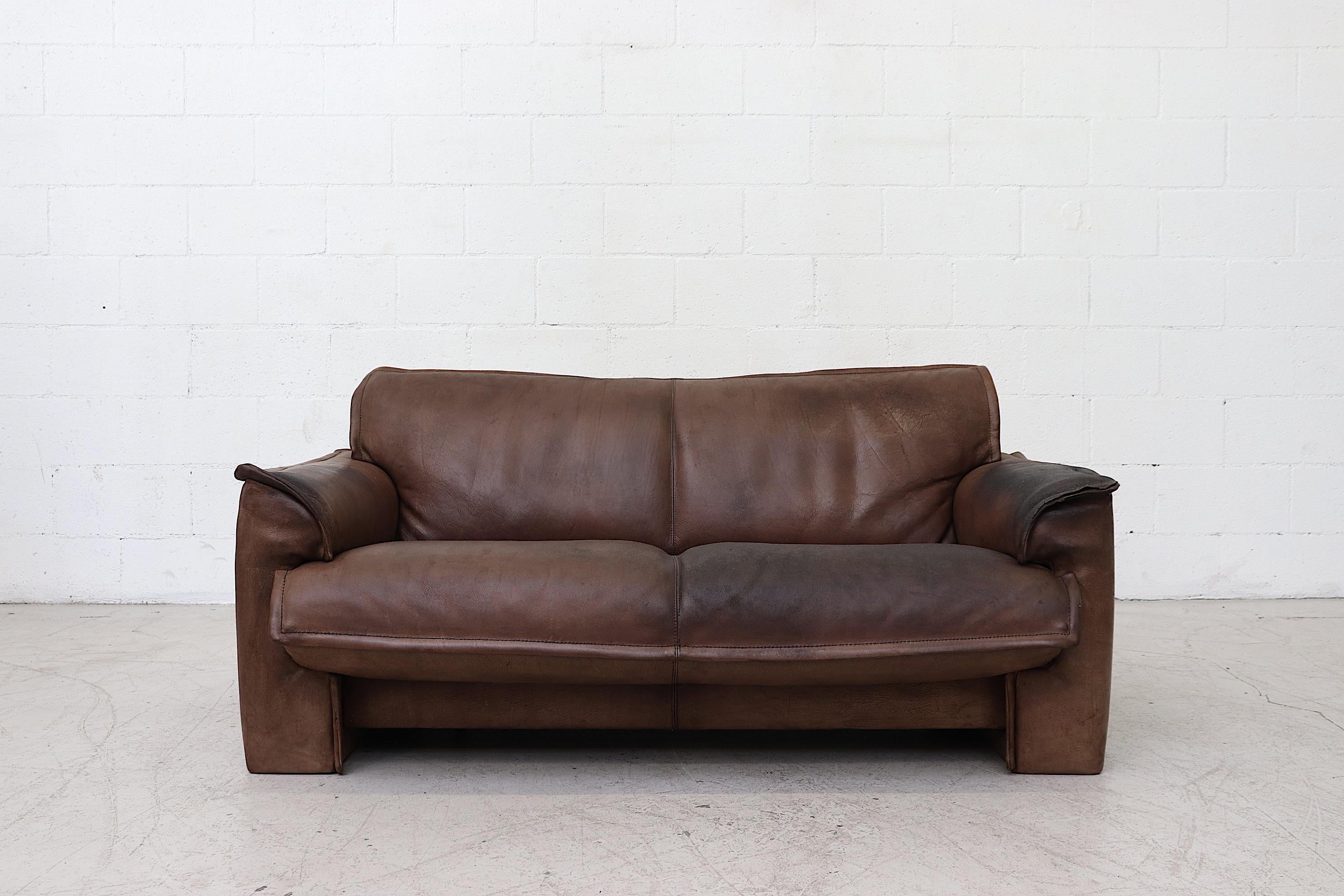Dark Leolux buffalo leather love seat sofa. Well worn in with heavy patina and visible signs of wear. Other similar sofas available. Listed separately. Actual color may vary slightly from photo.