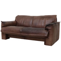 Well worn Leolux Buffalo Leather Love Seat