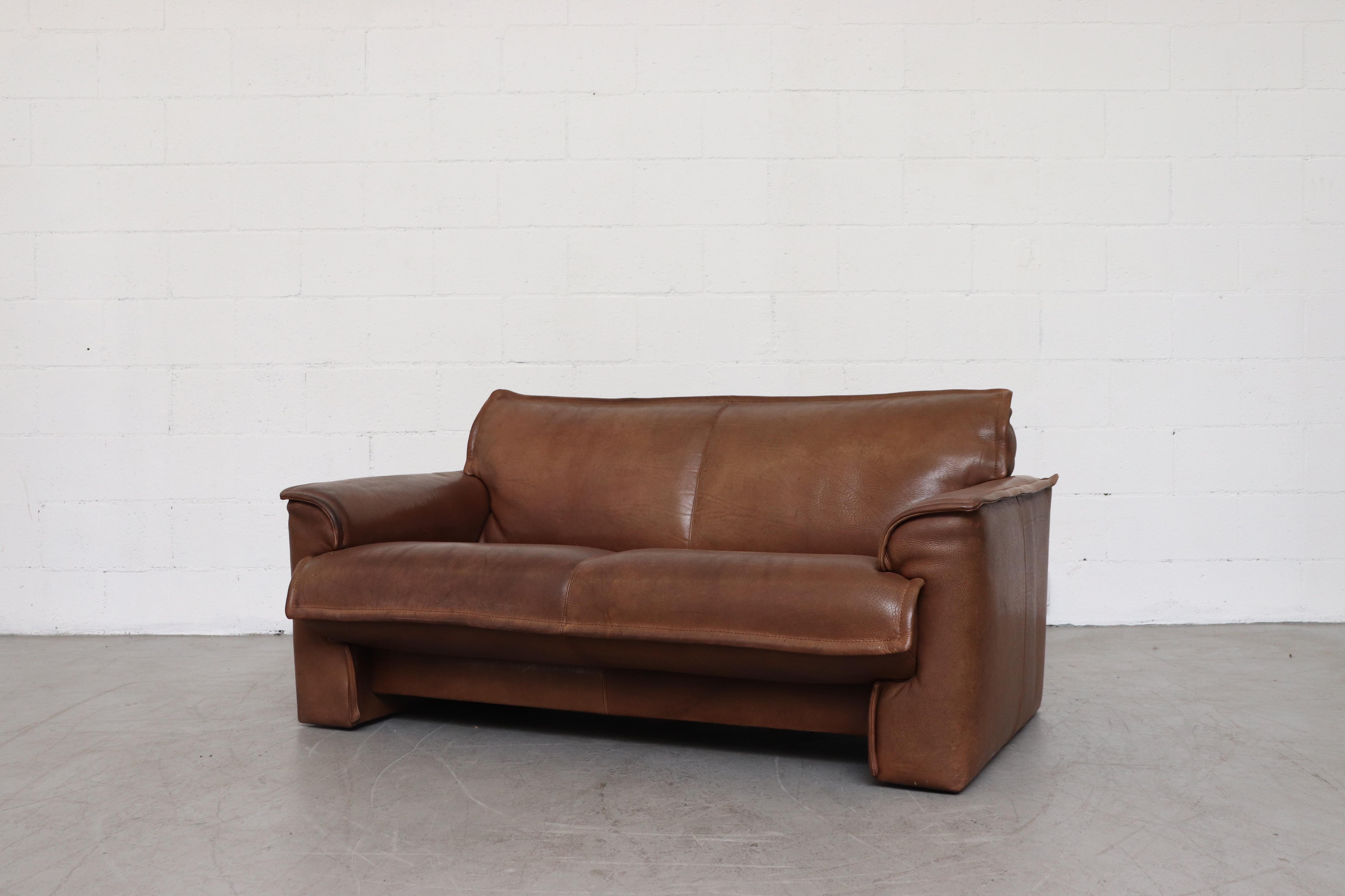 Leolux buffalo leather loveseat with heavy patina. In original condition with visible signs of wear. Wear is consistent with its age and usage. Several others available in varying patinas and listed separately (LU922412844482, LU922415582222)