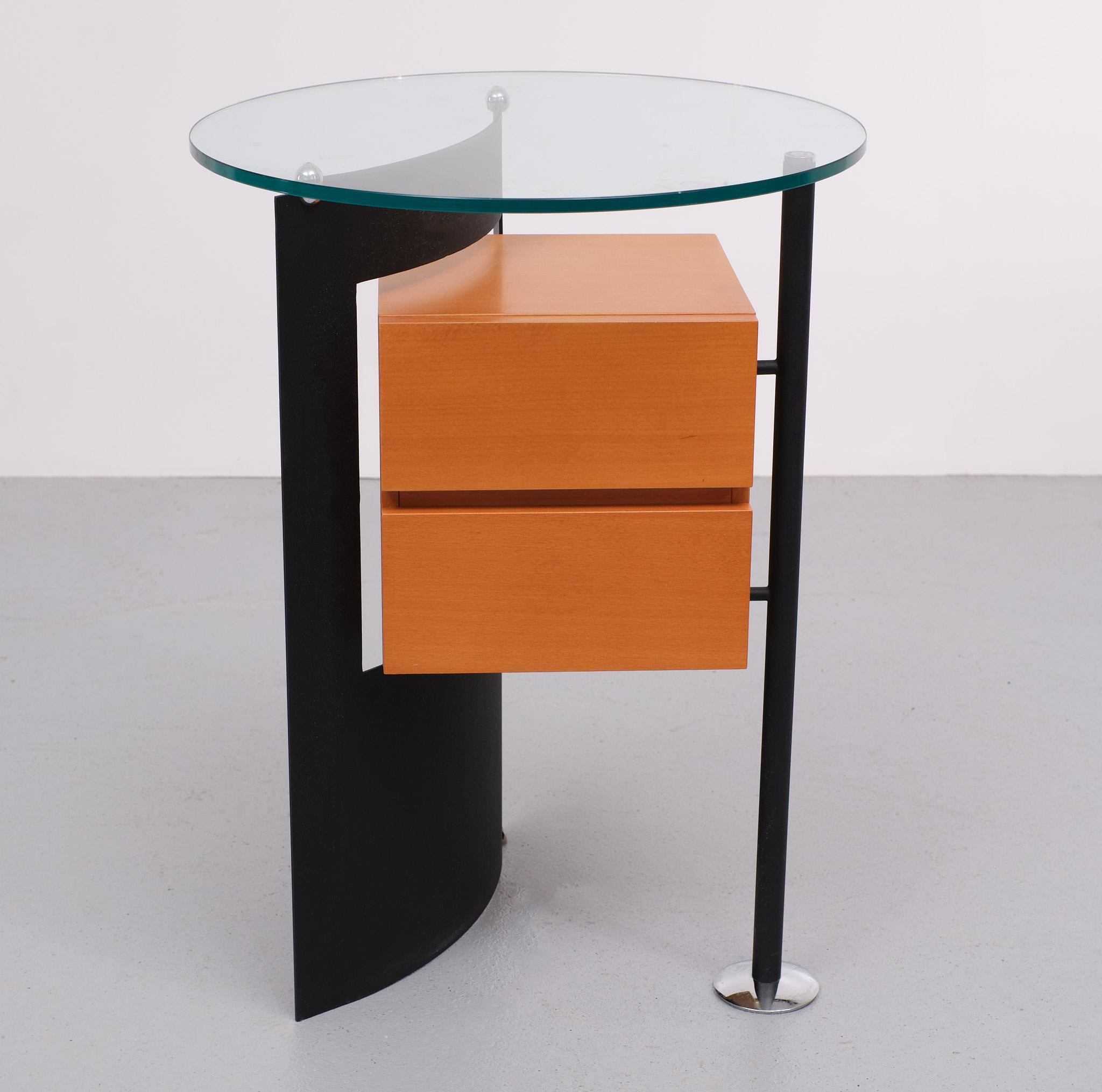 Love this unusual Post Modern side table. Beech wood curved steel, comes with 
a thick glass top. Two drawers. Very good condition. Manufactured by Leolux. Measures: 1980s 
Very good quality.