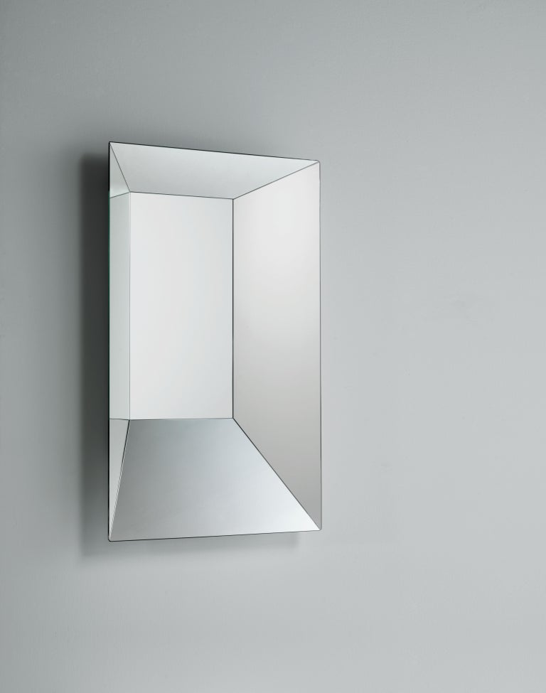 Mirror shaped in an artificial perspective, creating a “sfondato” effect, available in two different sizes. The converging frame is in mirrored glass and each side has different widths and inclinations, generating in this way fragmented and