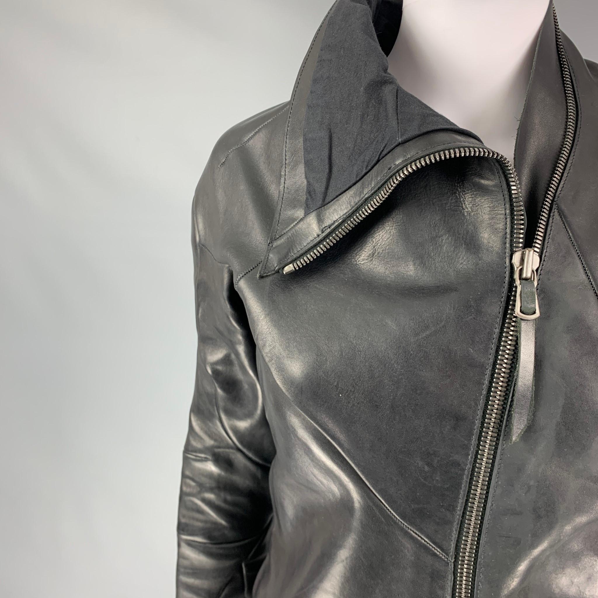 LEON EMANUEL BLANK jacket comes in a black horsehide leather featuring a slim fit, top stitching, high collar, and a asymmetrical zip up closure. Made in Spain.

Excellent Pre-Owned Condition.
Marked: 38
Original Retail Price: