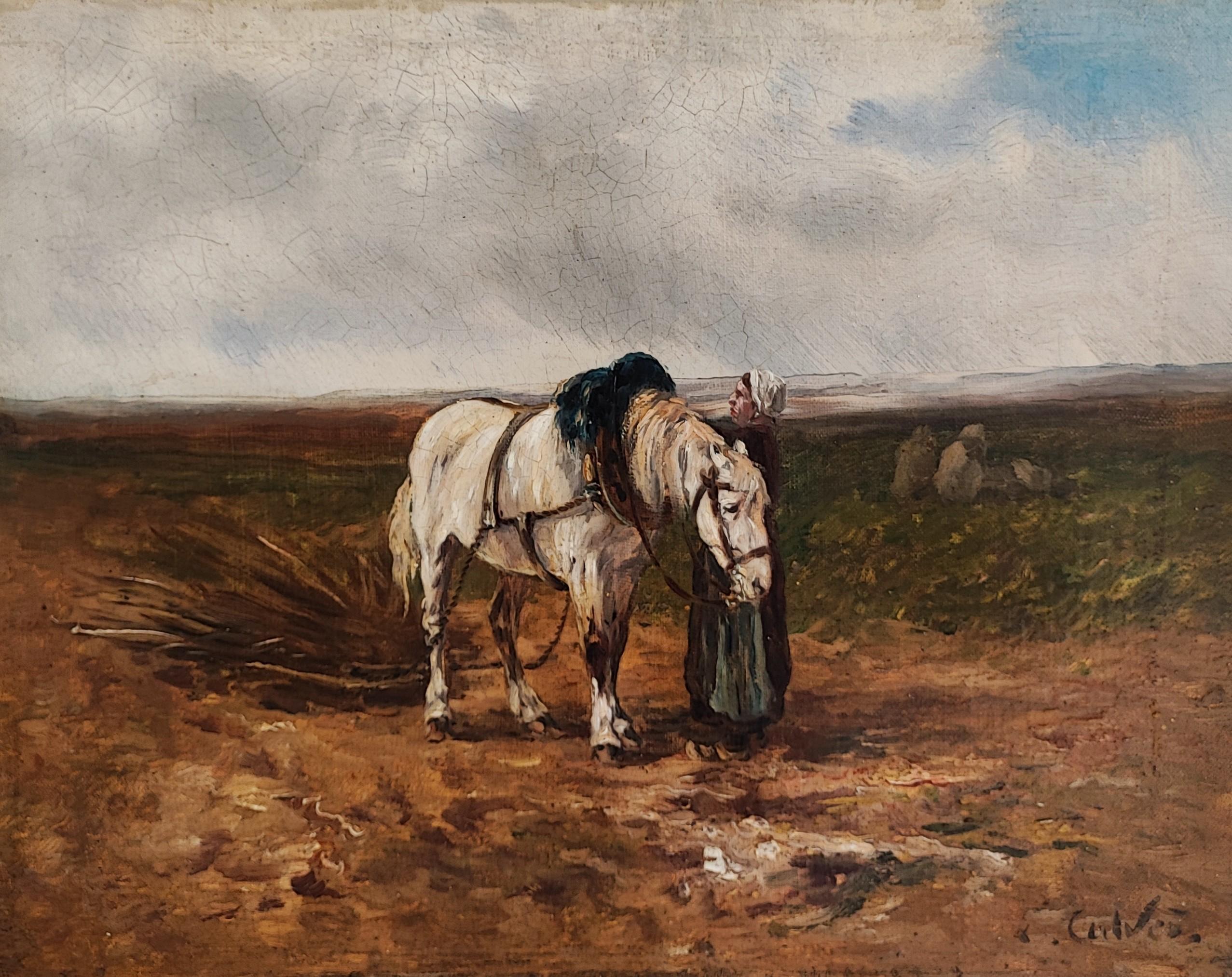 Donna nel campo che prepara un cavallo da tiro